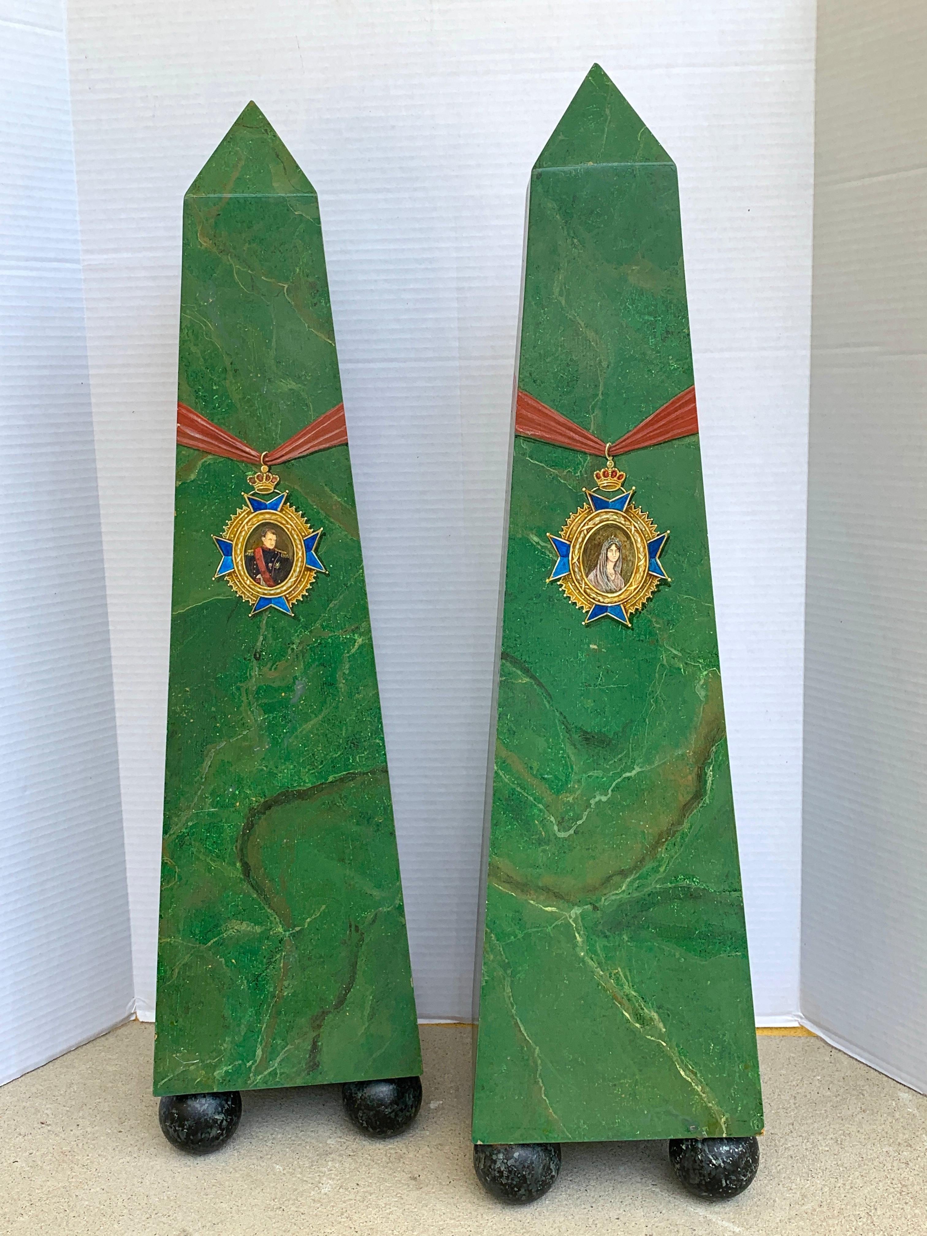Large pair of faux malachite neoclassical portrait obelisks, Each one raised on four ball feet, with portrait medallions on one side, and bows on the other.
Measures: Each obelisk is 8