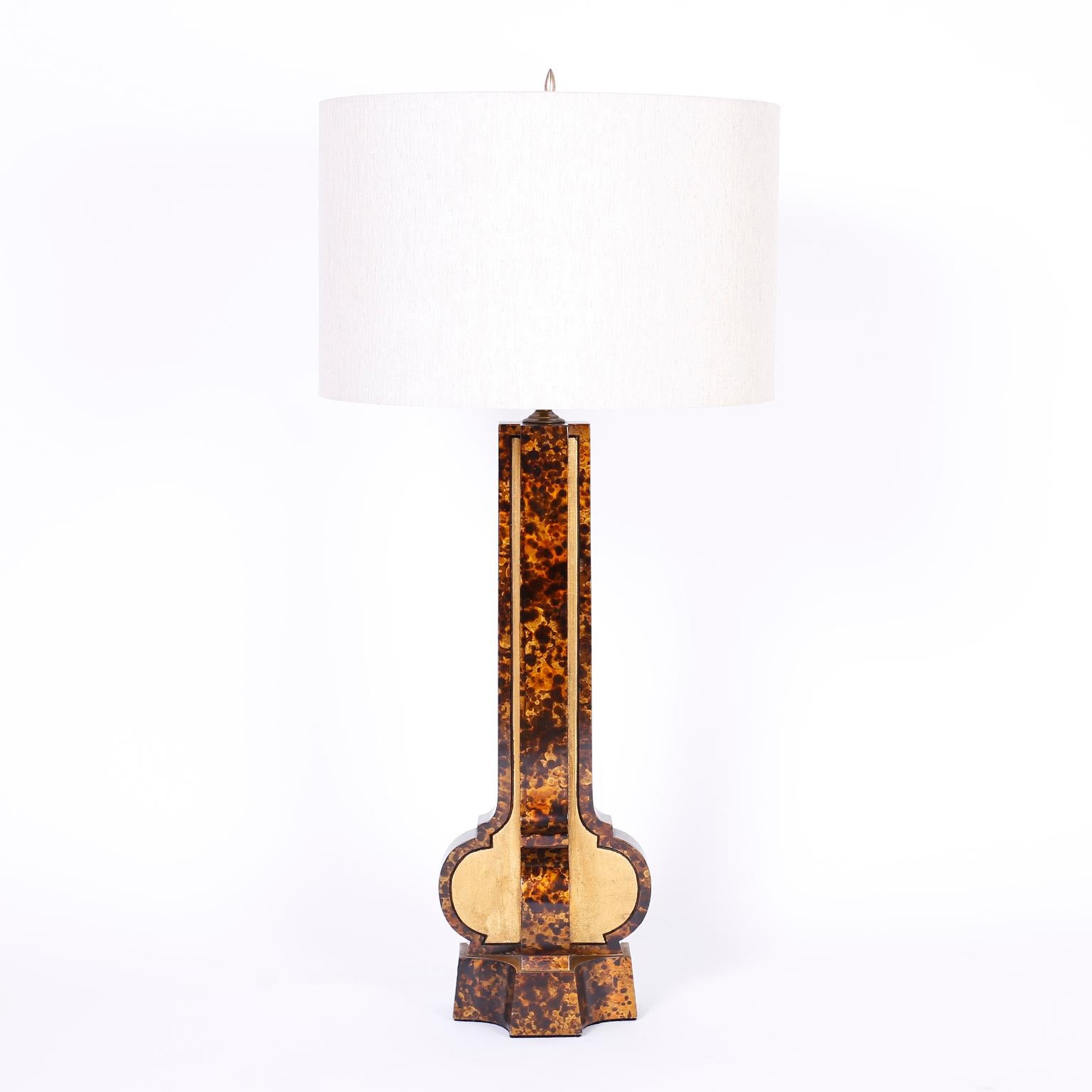 Pair of midcentury table lamps with a modern stylized classic form, crafted in wood with a faux tortoise lacquer technique separated by panels of gold leaf.