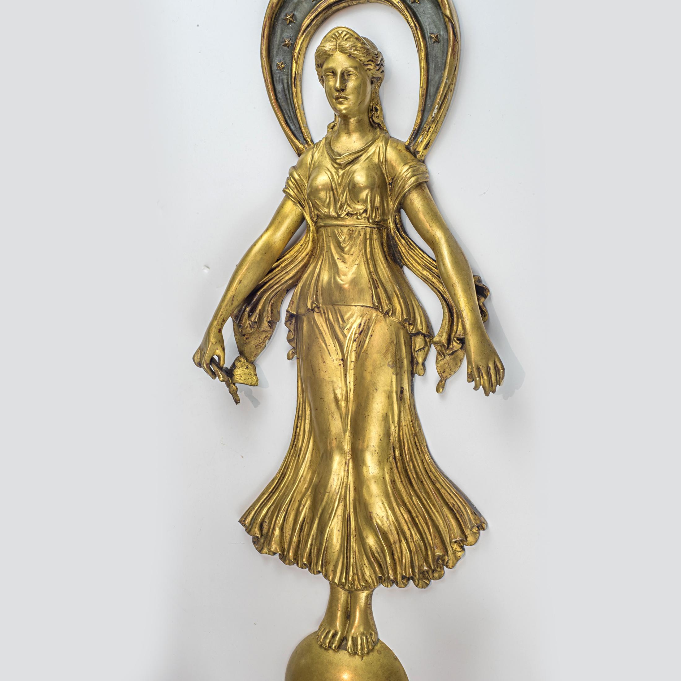 Large pair of French Empire style gilt bronze wall lights.
Surmounted by a classical female figure standing atop an orb and holding butterflies in each hand, above two tier structure issuing three candle arms cast with melusines above four arms in