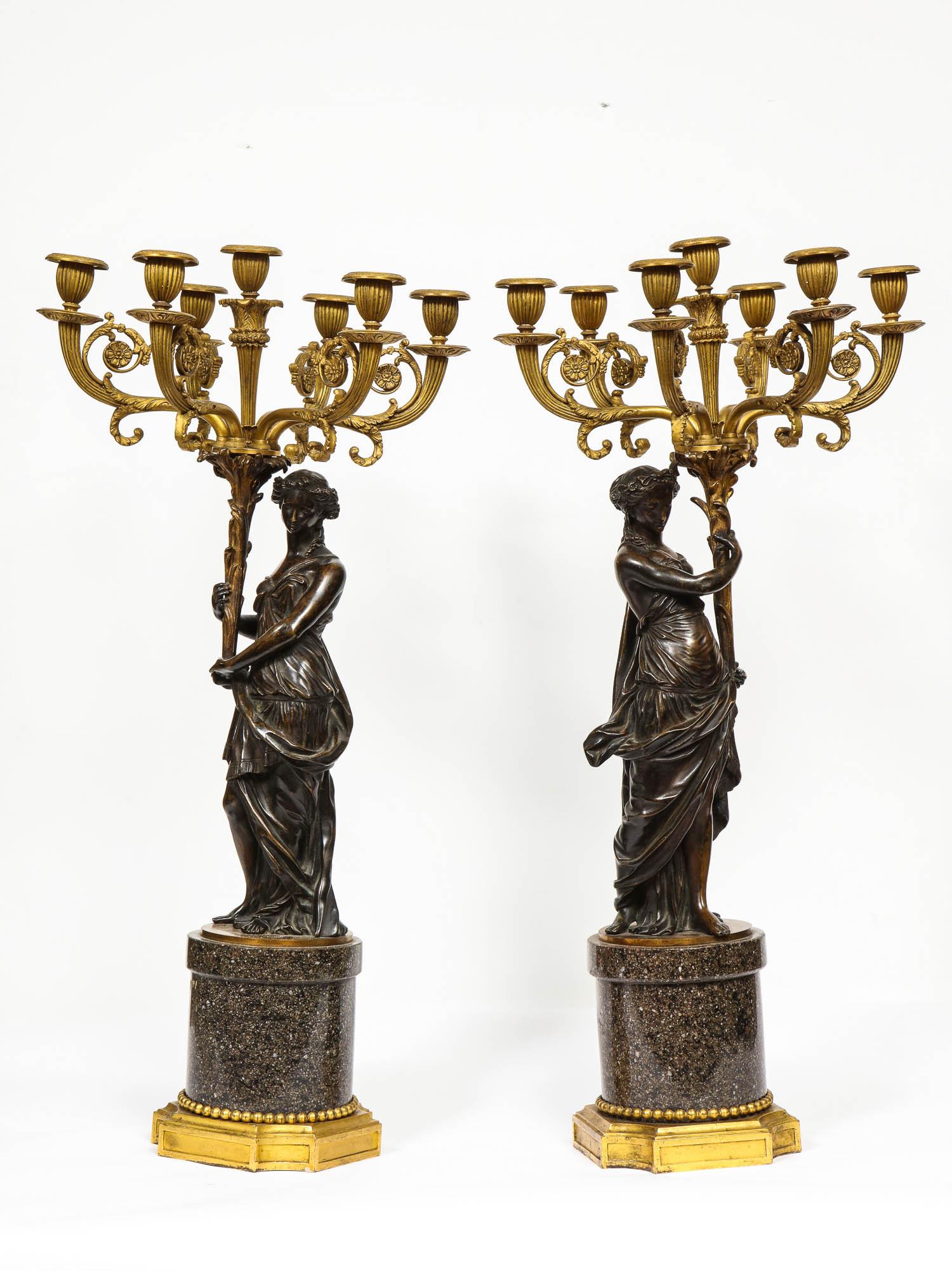 Large pair of French gilt and patinated bronze seven-light candelabras on Swedish Porphyry bases, depicting female maidens.

Very high quality. Could be turned into lamps.

Late 18th-early 19th century.

Measures: 29