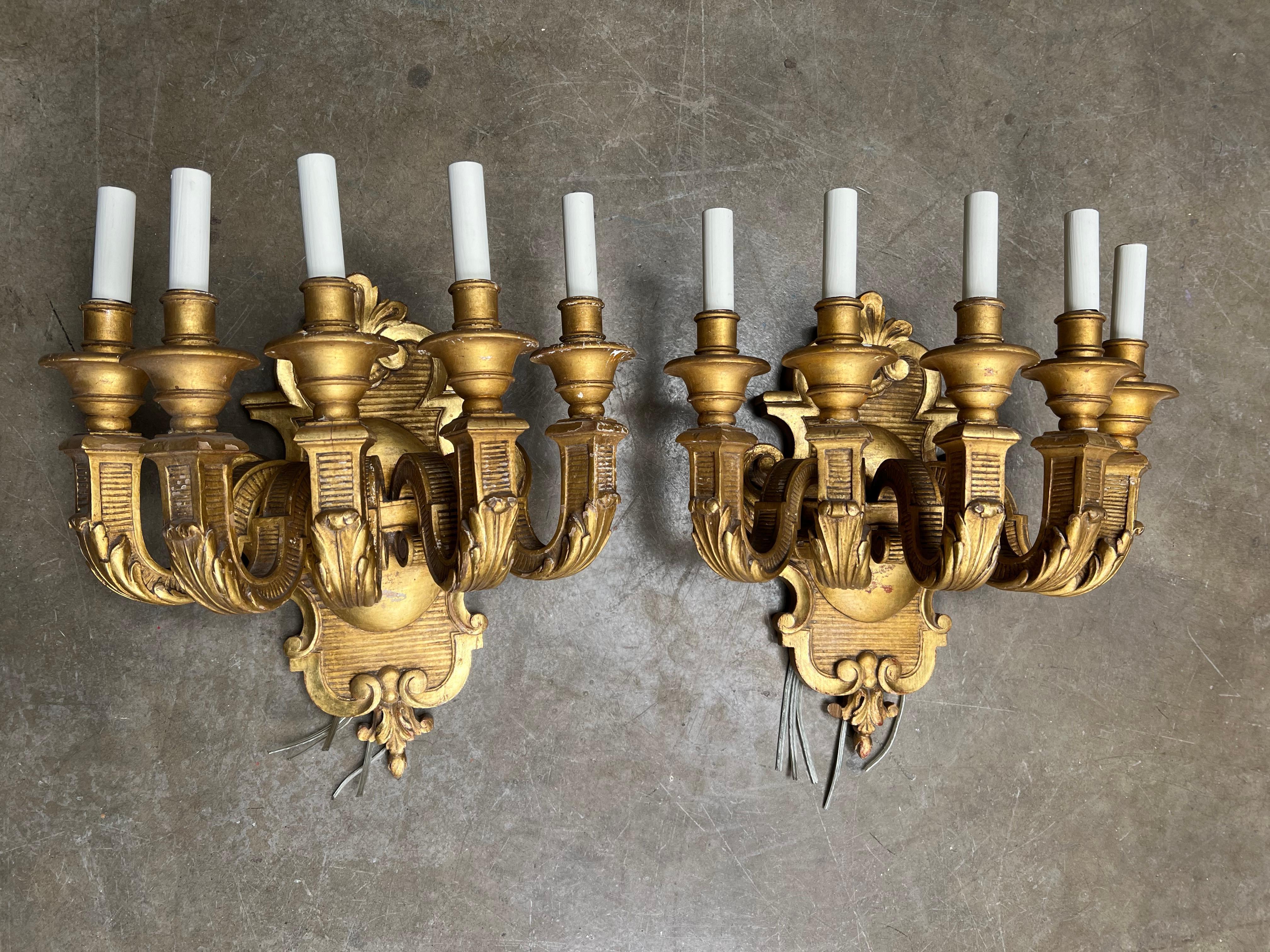 A large pair of French neoclassical style five arm giltwood sconces - wall lights.  These large impressive sconces are currently wired and the height is to the top of the candles.  
