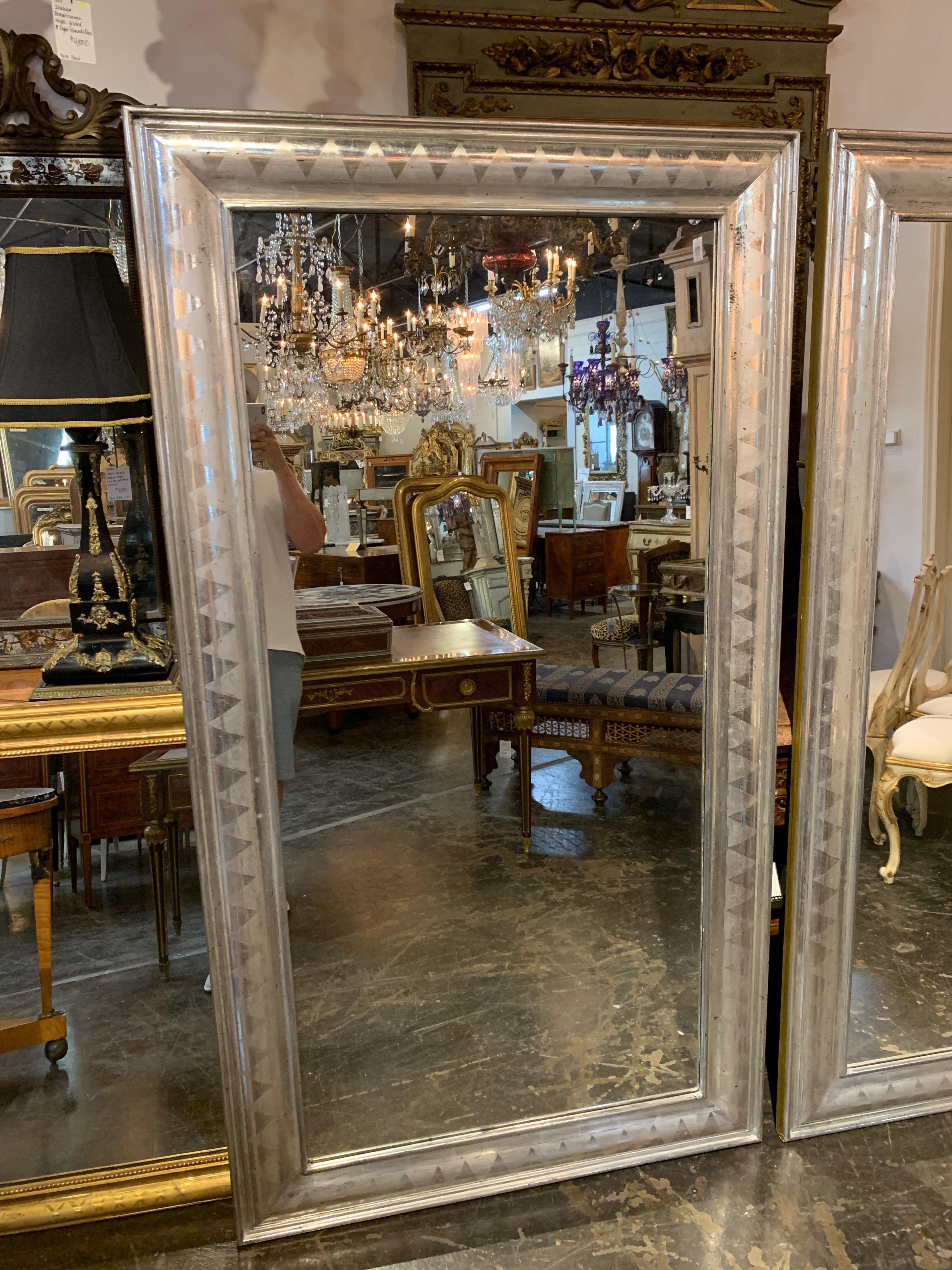 Amazing pair of large French high style silver leaf mirrors. These are absolutely gorgeous. Very impressive for a large space.