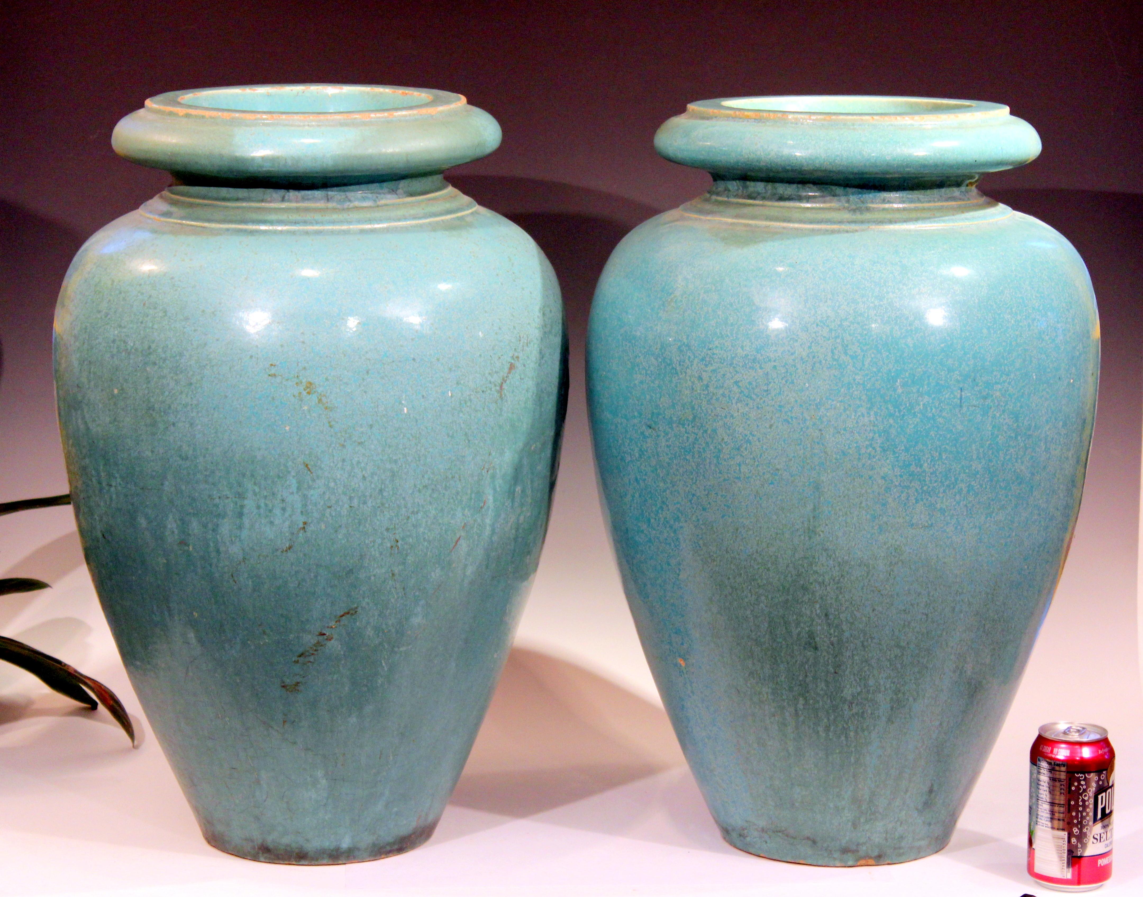 Large pair of garden urns by the Galloway Terracotta company of Philadelphia in green/turquoise crystalline glaze, circa early 20th century. Measures: 24
