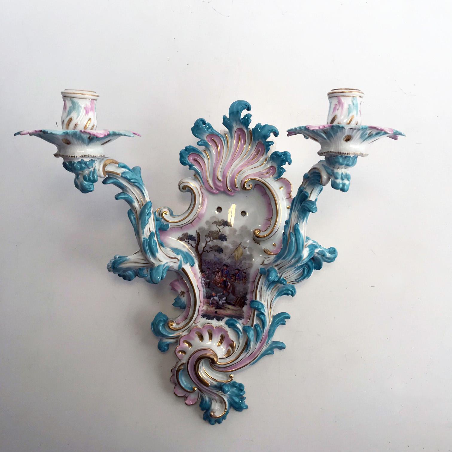This antique pair is hard paste, German and painted in the palette of Meissen but unmarked , the pink and blue is entirely characteristic of Meissen of the third quarter of the 19th century. (it might also conceivably be by Sitzendorf.) Each is