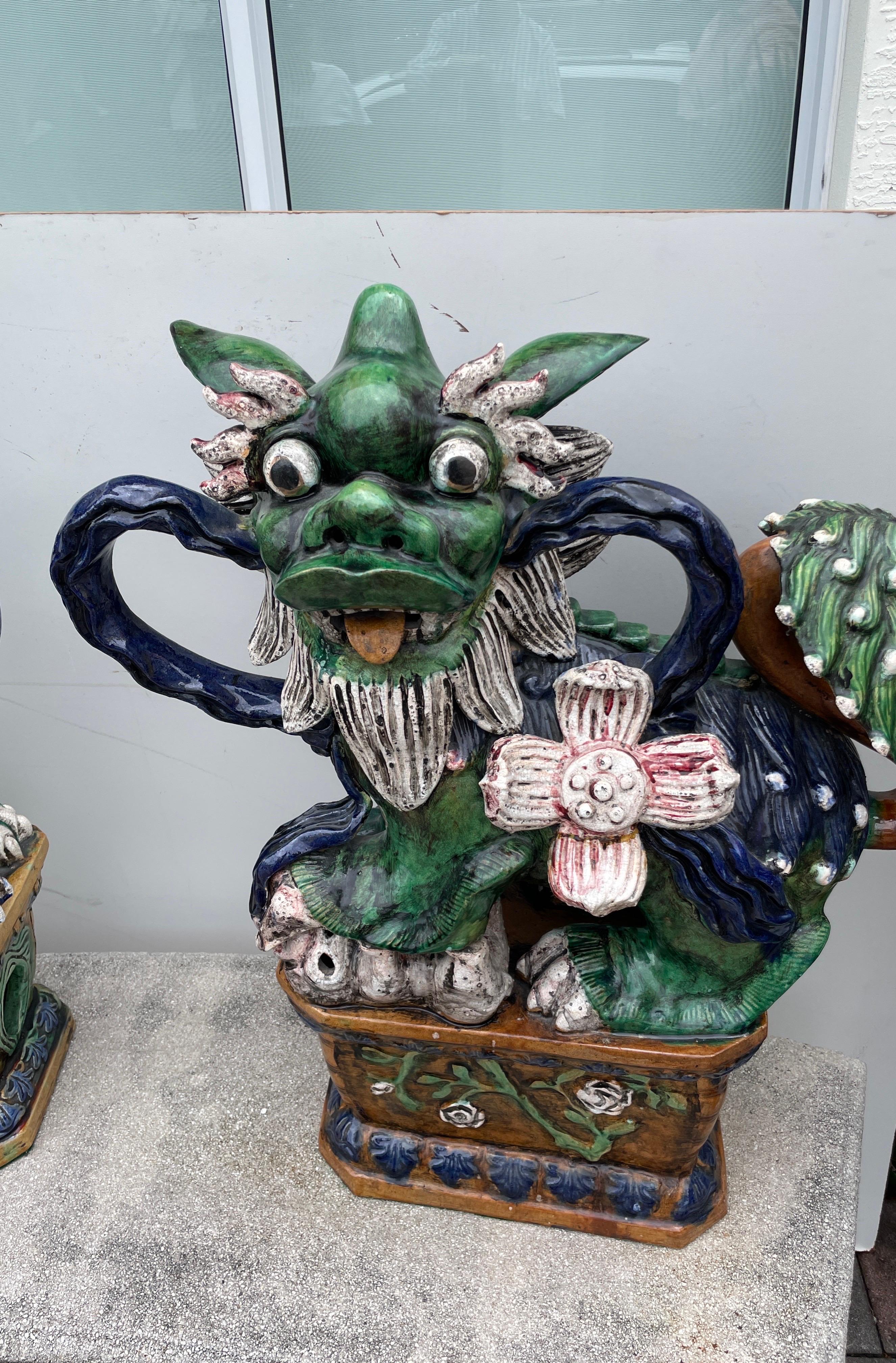 Monumental pair of wonderful multicolored glazed terra cotta foo dogs. The details are outstanding. A very unusual and rare pair. 