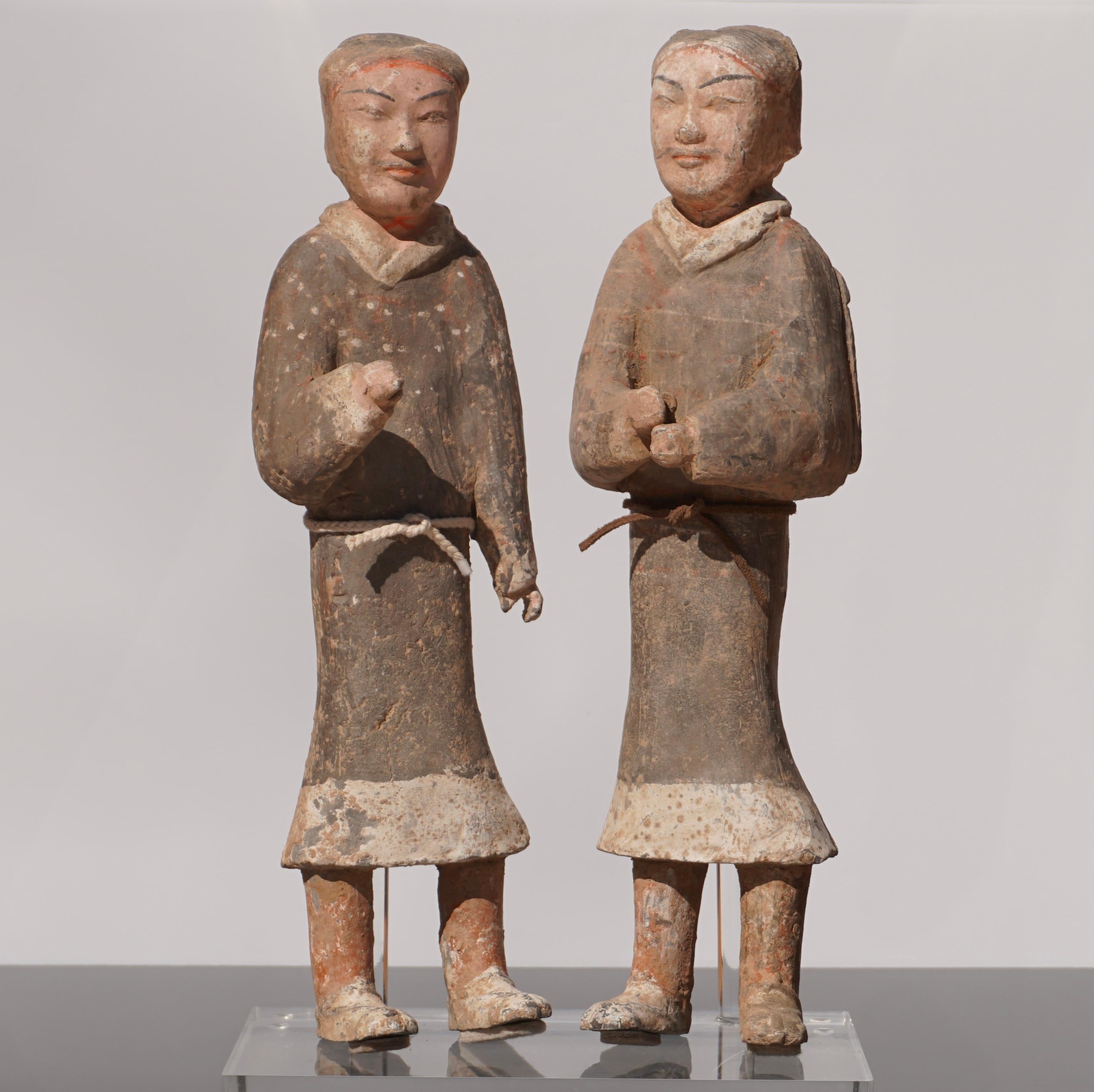 A large pair of Han dynasty terracotta guardsmen 
Pottery figures with original ornate and decorative paint throughout. The long robes with intricate patterns and detailed facial features. 
China, early Western Han dynasty (3rd–2nd BC)
