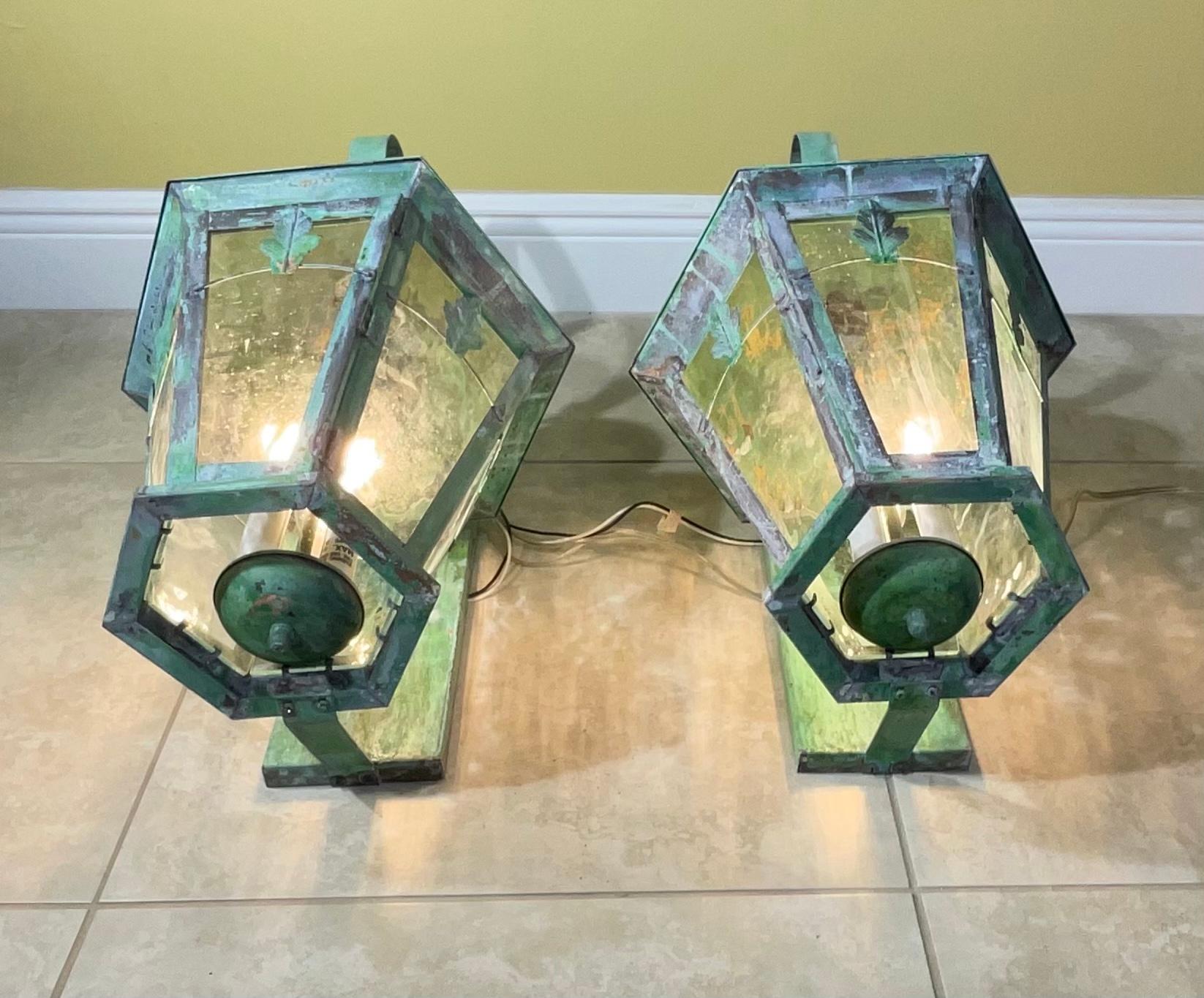 Quality artistic pair of wall lantern handcrafted from solid brass with three 40/watt lights each lantern up US code suitable for wet location. 
Beautiful oxidise patina.