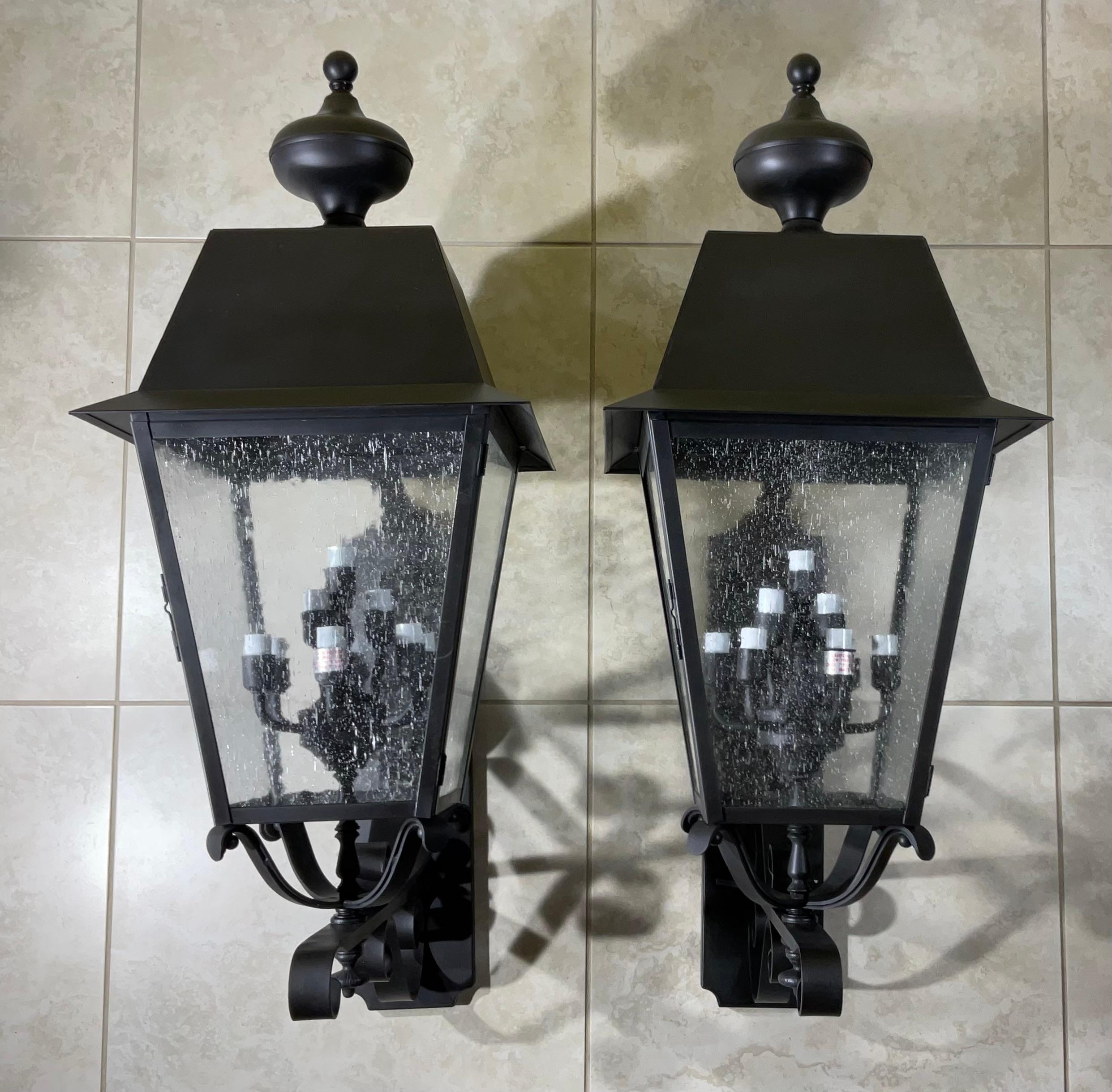Exceptional large pair of vintage wall lantern made of solid brass, quality workmanship, electrified with nine 25/watt lights each, black  color coated protection , Great light exposure, seeded glass on four sides.
UL approved up to US code