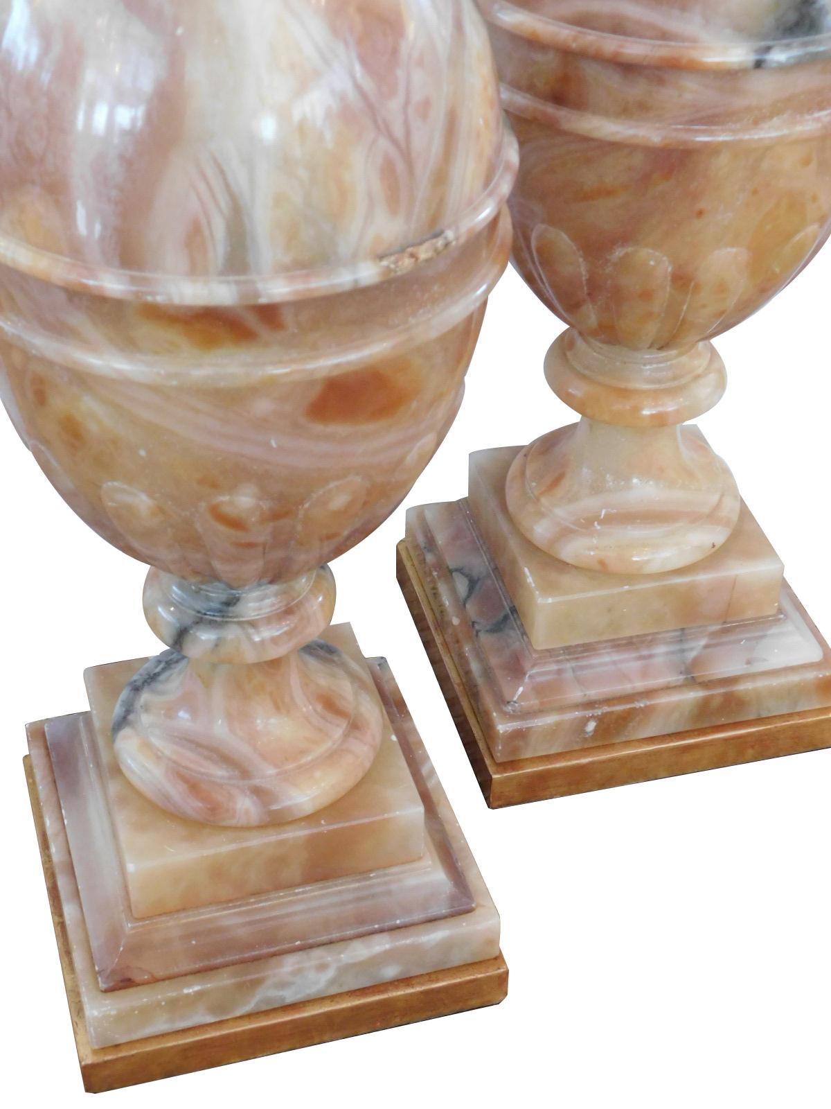 Each well-figured lamp of well-figured sienna-colored onyx with gray and black veining with flared neck above a bulbous lobed body over a splayed base and giltwood plinth; height 24