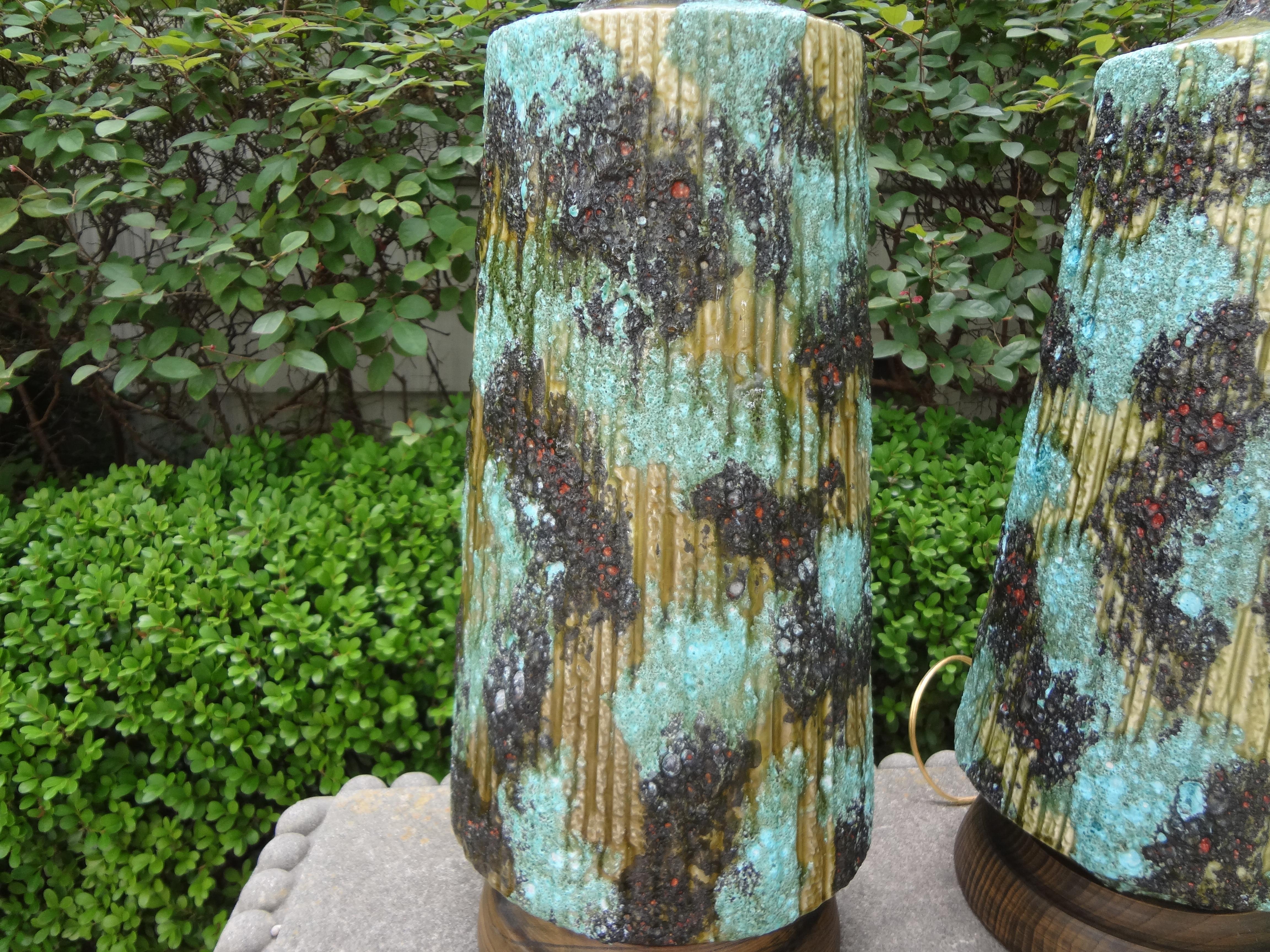 Stunning large pair of Italian glazed ceramic lamps. This unusual pair of Italian lamps are in a gorgeous shade of turquoise mounted on wood bases and newly wired to U.S. standards. These fantastic Italian Hollywood Regency lamps are attributed to