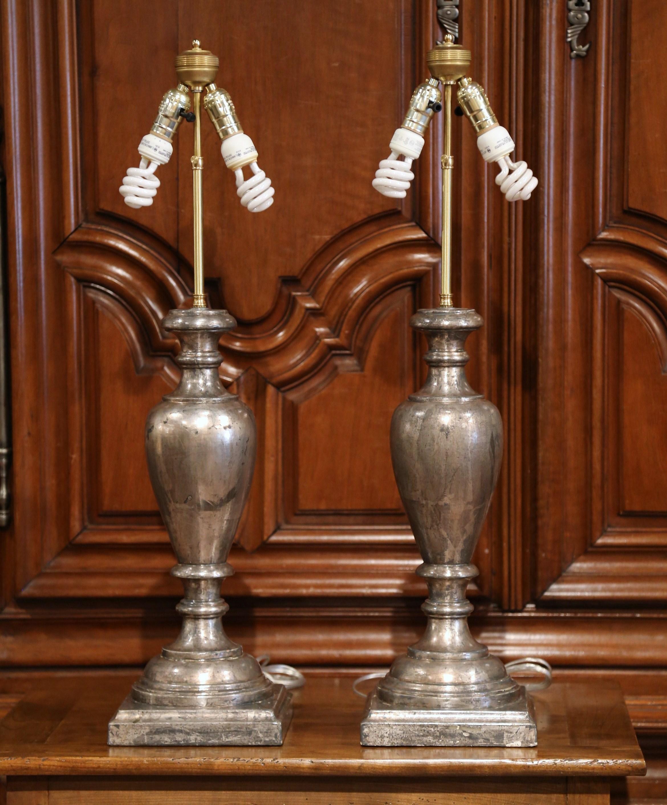 Incorporate extra light into a living room or bedroom with this pair of hand carved and hand painted neoclassical lamp bases from Italy. The tall, stately bases are in the shape of a traditional antique urn and sit on a sturdy, square base. Each