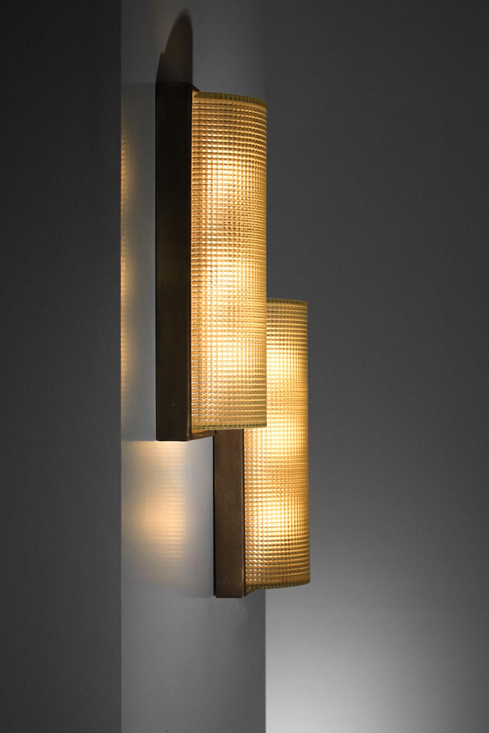 Large pair of Italian modernist wall lights from the 1940s. Solid brass structure with a patina finish and domed, embossed Murano glass shades.  Understated and very elegant design. In good vintage condition with a beautiful patina on the brass,
