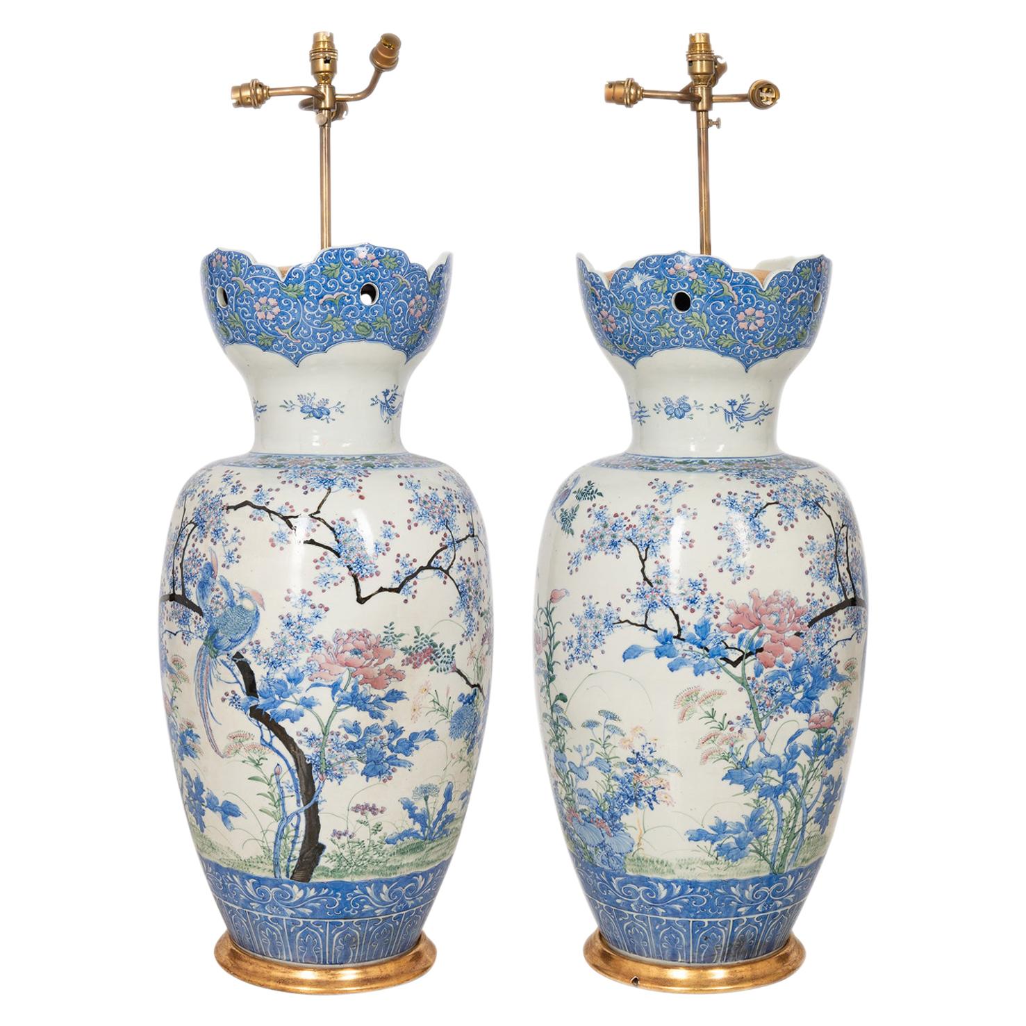A large good quality pair of early 20th century Japanese Yokohama vases / lamps, each with flared necks, with pierced petal shaping, white ground, blue boarders with classical motif decoration. Wonderful exotic flowers, birds and blossom trees,