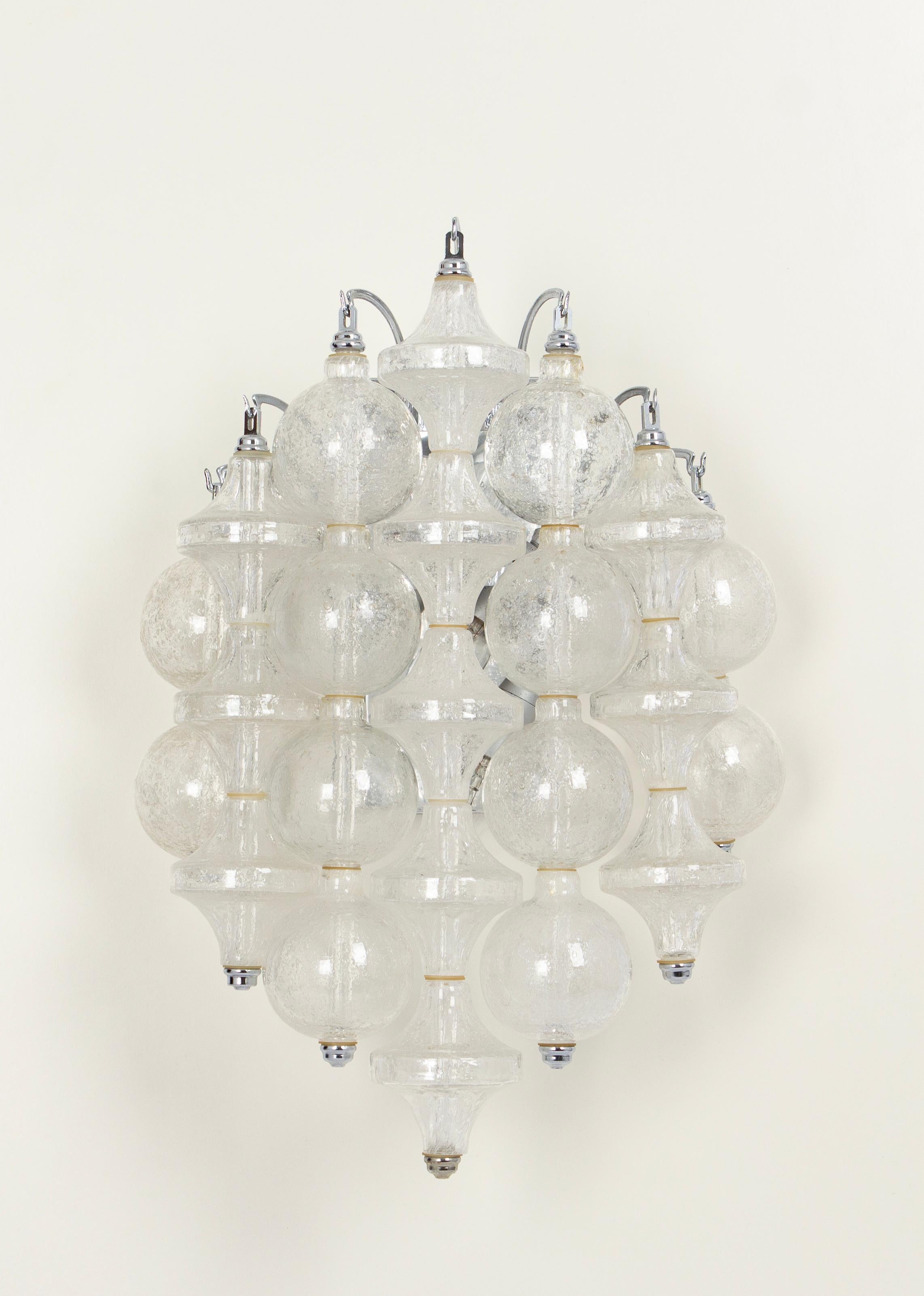 Wonderful pair of midcentury wall sconces, made by Kalmar, Austria, manufactured, circa 1970-1979.
Each tulip-shaped glass is handmade which makes each glass piece a unique piece. Each sconce is made of many glass pieces on a metal frame.

Heavy