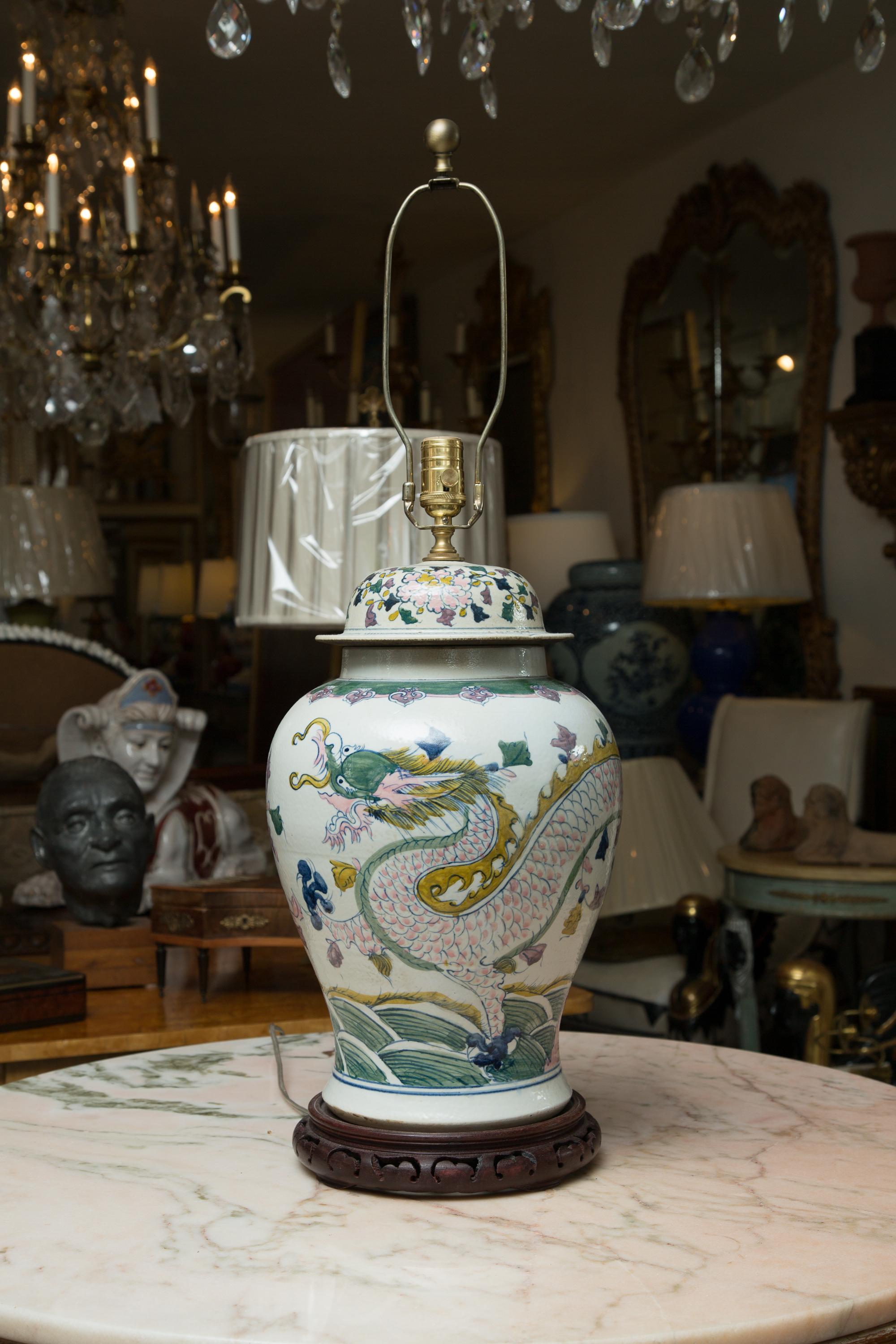 Soft pastels with a subtle dragon are hand painted on these large lidded urns and made into table lamps. Priced individually.