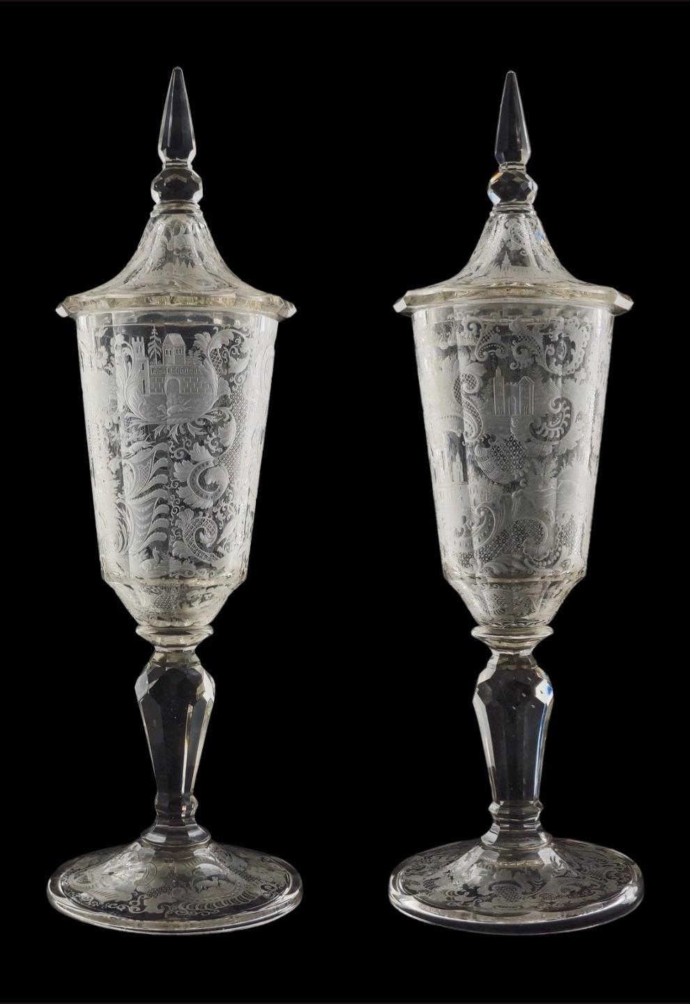 An outstanding pair of covered vases, or Deckelpokals, in blown glass with wheel-cur engraving. Bohemia at this time was the centre of elaborate but exceptionally fine glass cutting, and this pair shows us the industry at its height, before the
