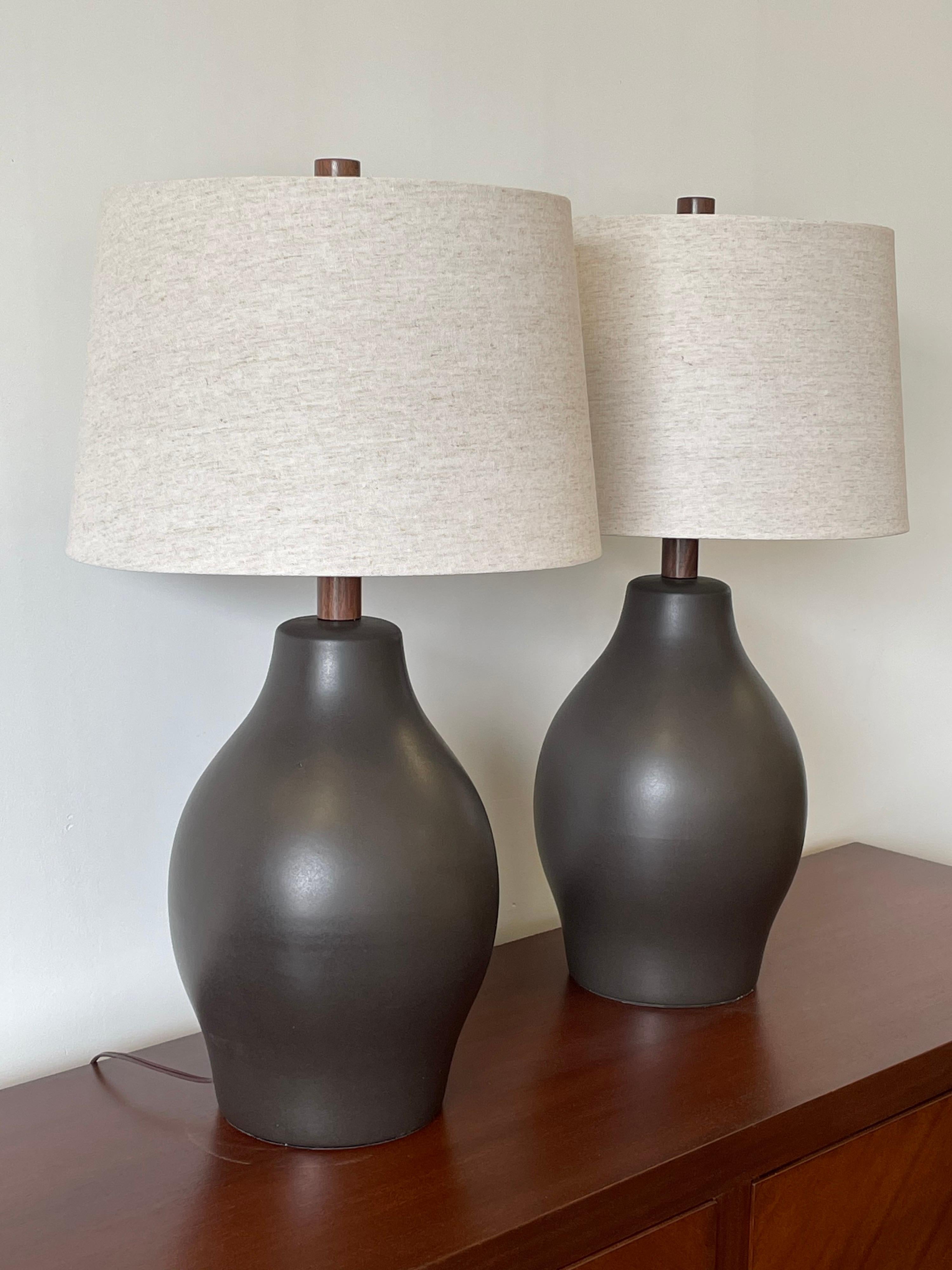 Large pair of lamps by ceramicist duo Jane and Gordon Martz for Marshall Studios. Wonderful matte gunmetal color bulbous form.

These lamps were sourced as “new old stock” ceramic lamp bases. They are authentic Martz bases that hadn't yet been