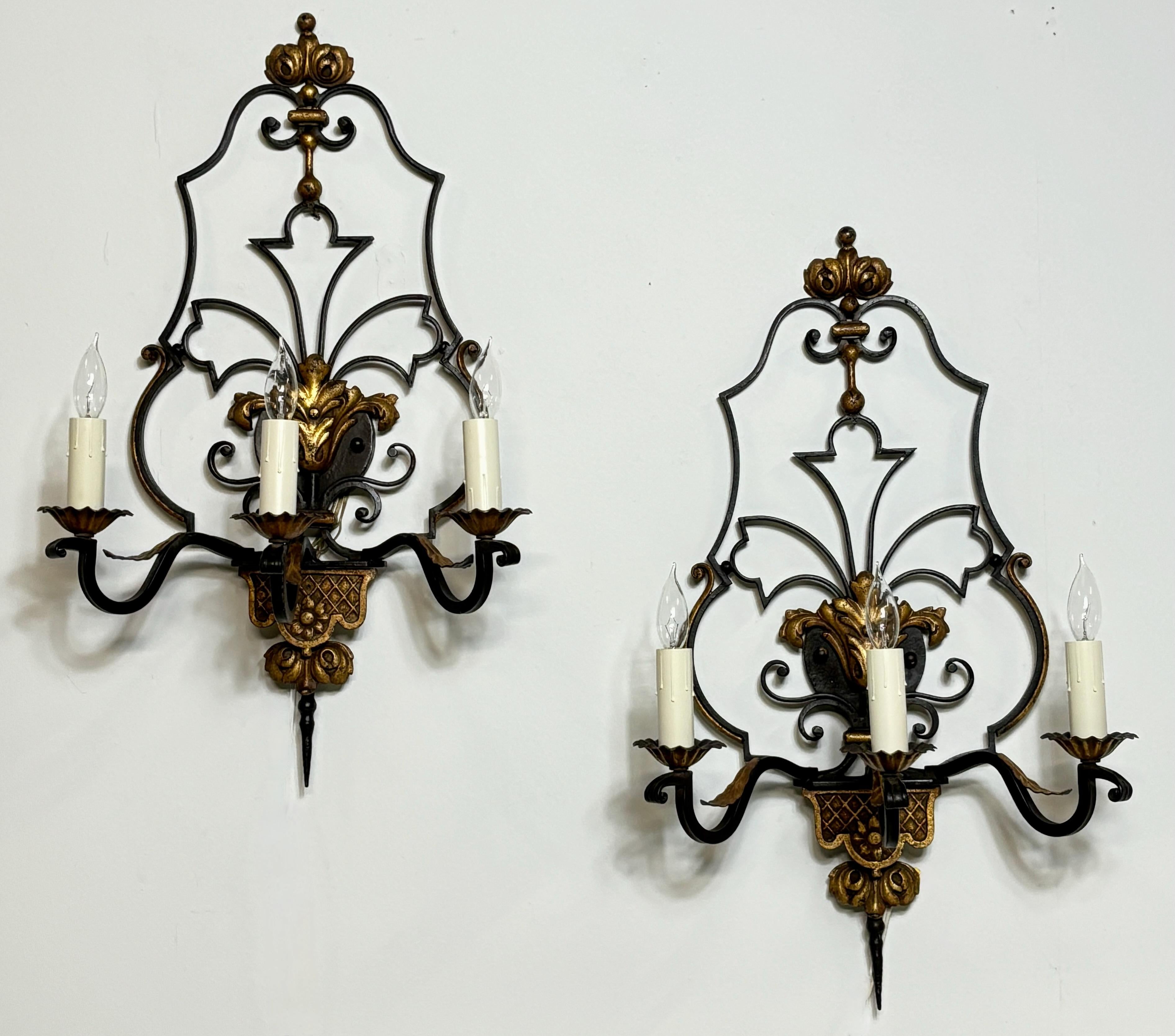A very stylish large pair of traditional Mediterranean style wrought and cast iron wall sconces with the original black and gold paint.
These have been recently re-wired and are ready to install.
Truly impressive presence and exceptional quality.
In