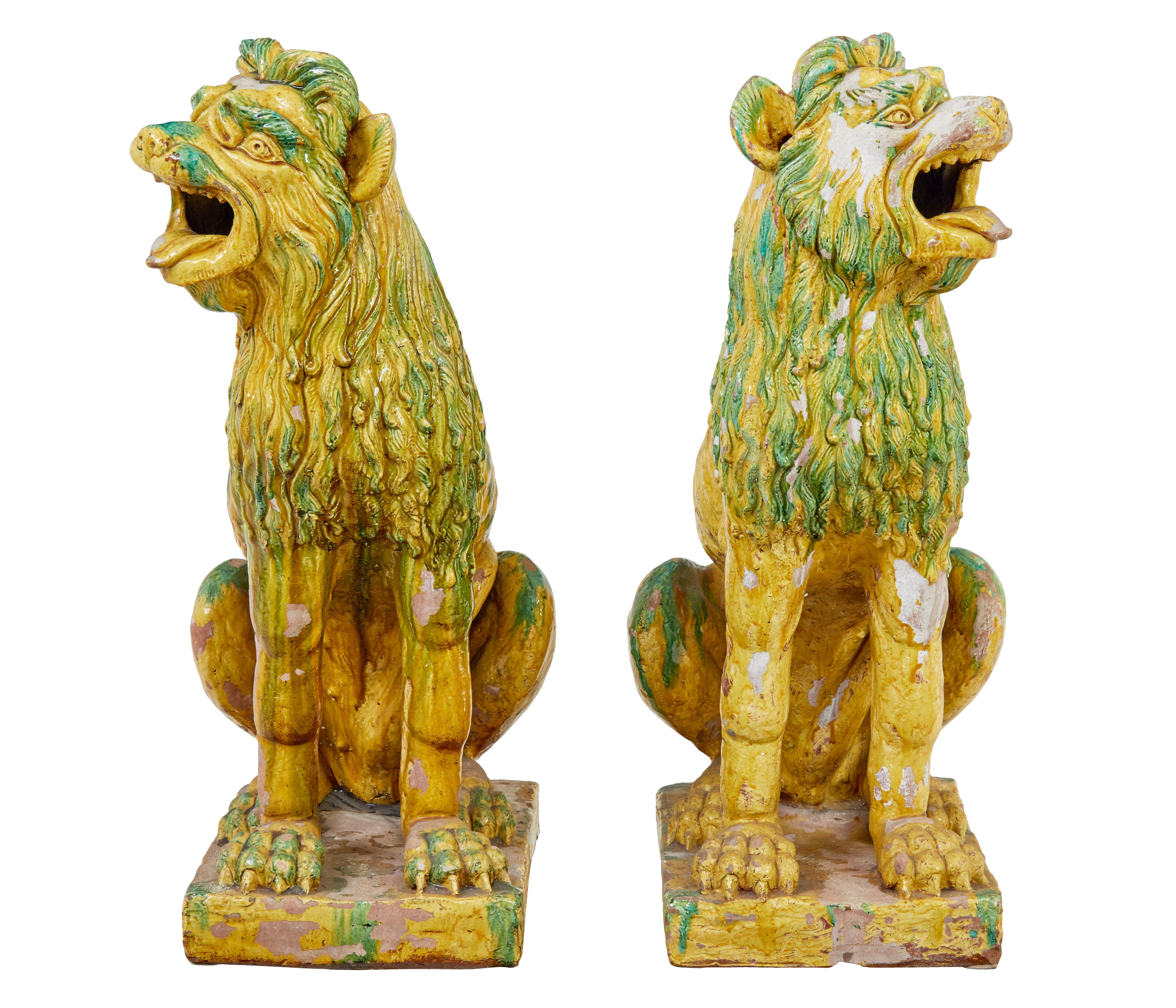 Large pair of mid 20th century Indonesian salt glazed decoration dogs circa 1950.

Rare pair of 20th century salt glaze dog statues.

We are putting these down as 1950 but they could be earlier.

Glazed with greens, yellows and reds.  These are a
