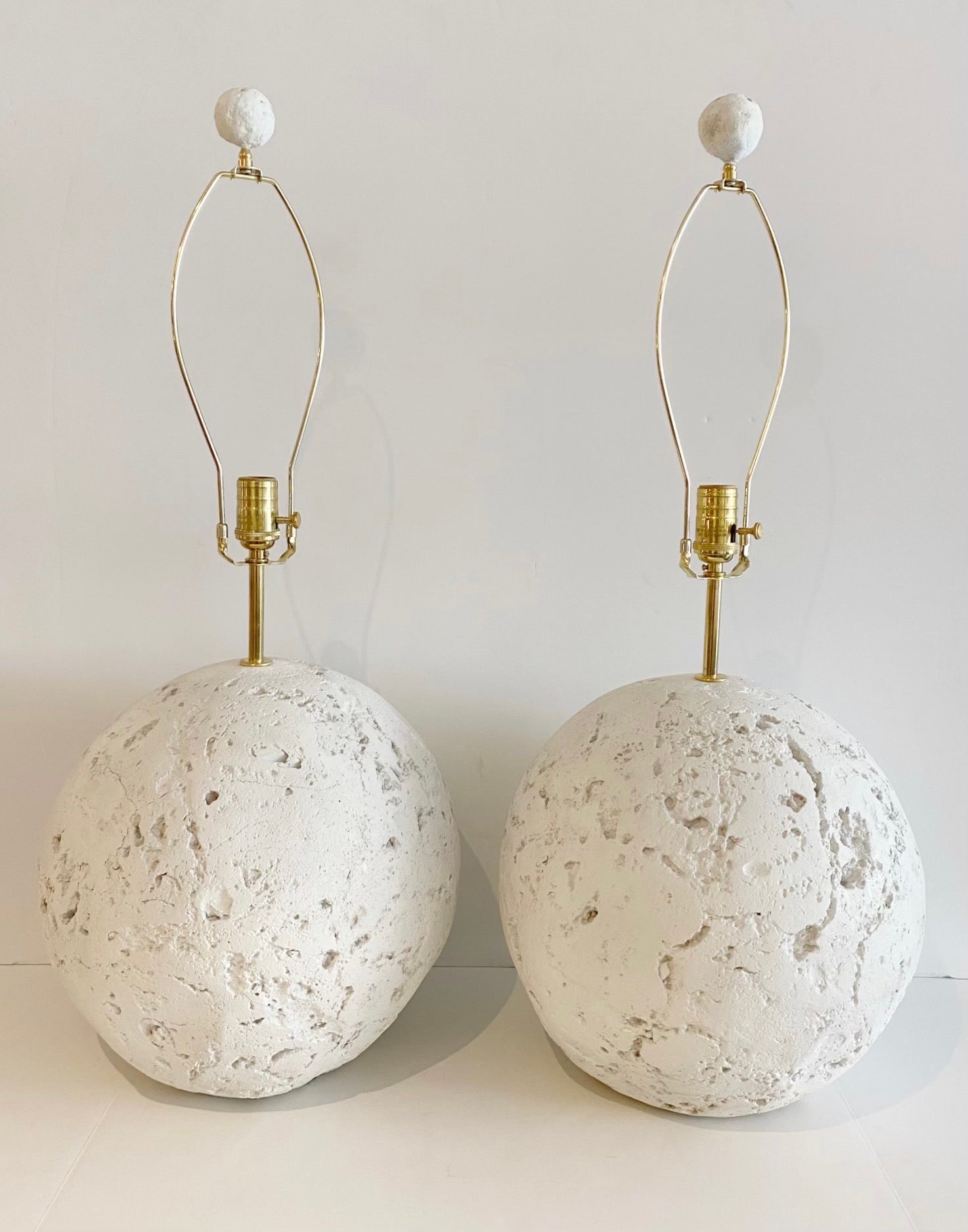 Large Pair of midcentury Coquina Coral Stone Style Orb Lamps 
USA, circa 1970s
Each one of sculpted naturalistic form, realistically cast and modeled. Fitted with fine brass lamp fittings. Complete with harps and matching finials. Ready to shade