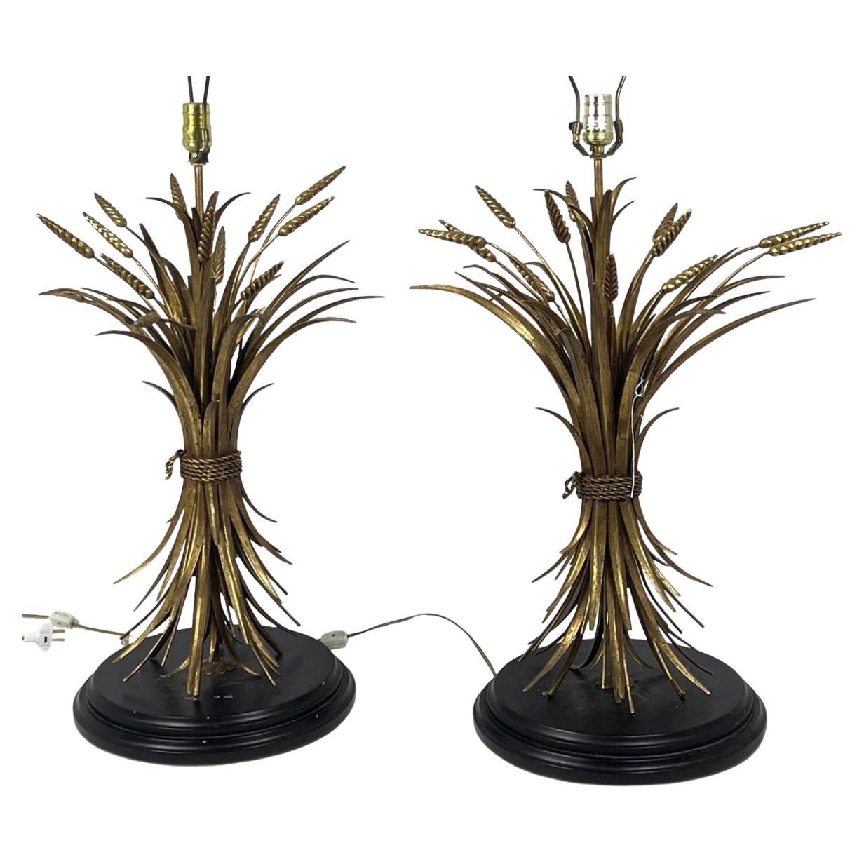 Beautiful large Italian sheaf of wheat gilt metal table lamps are impressive and will add an air of elegance to any room. Gilt metal with ebonized bases these lamps have been newly rewired and work no problem.