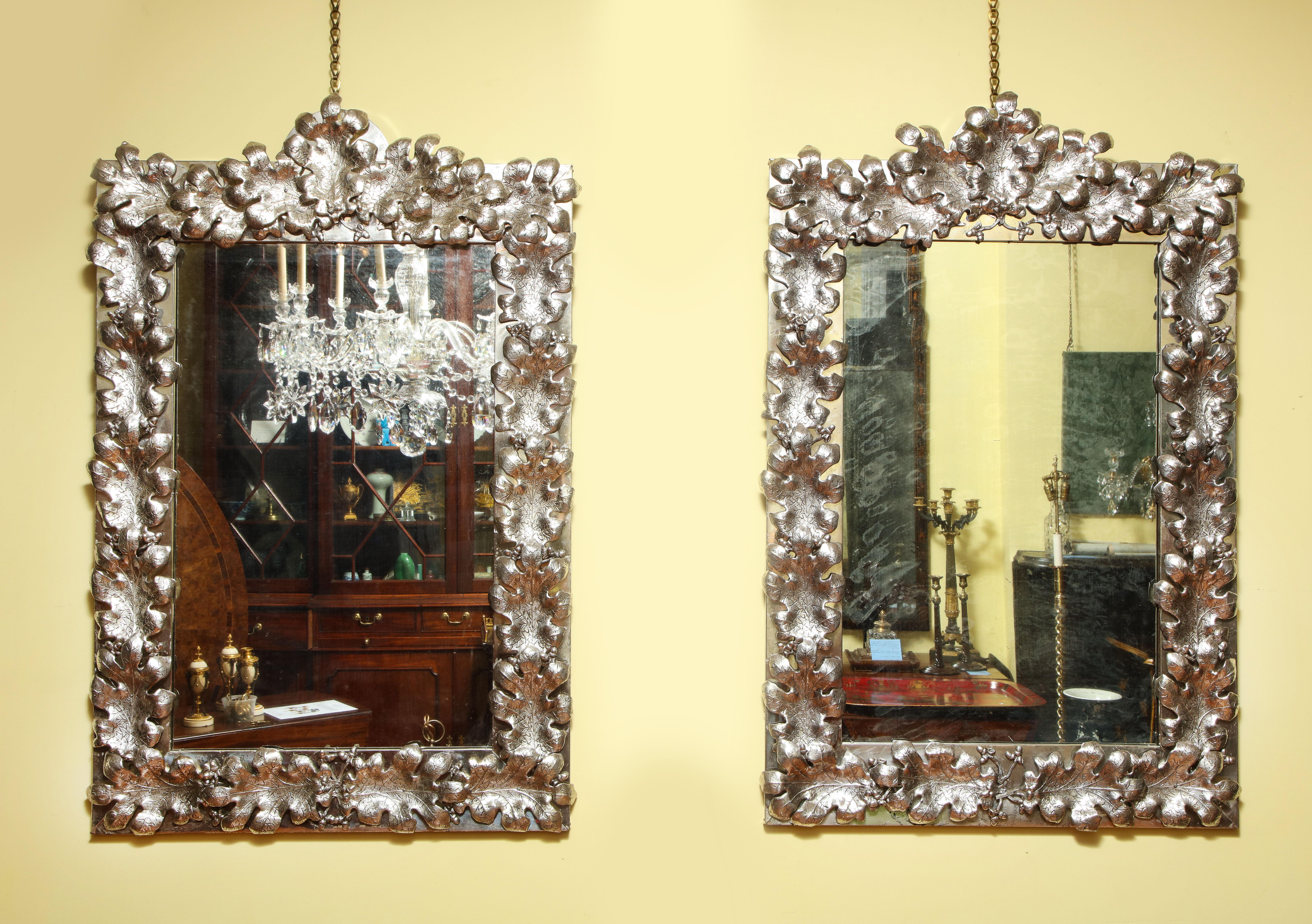 Fine and Exceptional Large Pair of Mid-Century Modern rectangular arch top silvered tin oak leaf mirrors, each with 21 hand-molded silver plated and lacquered oak leaves alternating with silvered lead sprigs of acorns, on silvered frames on hardwood