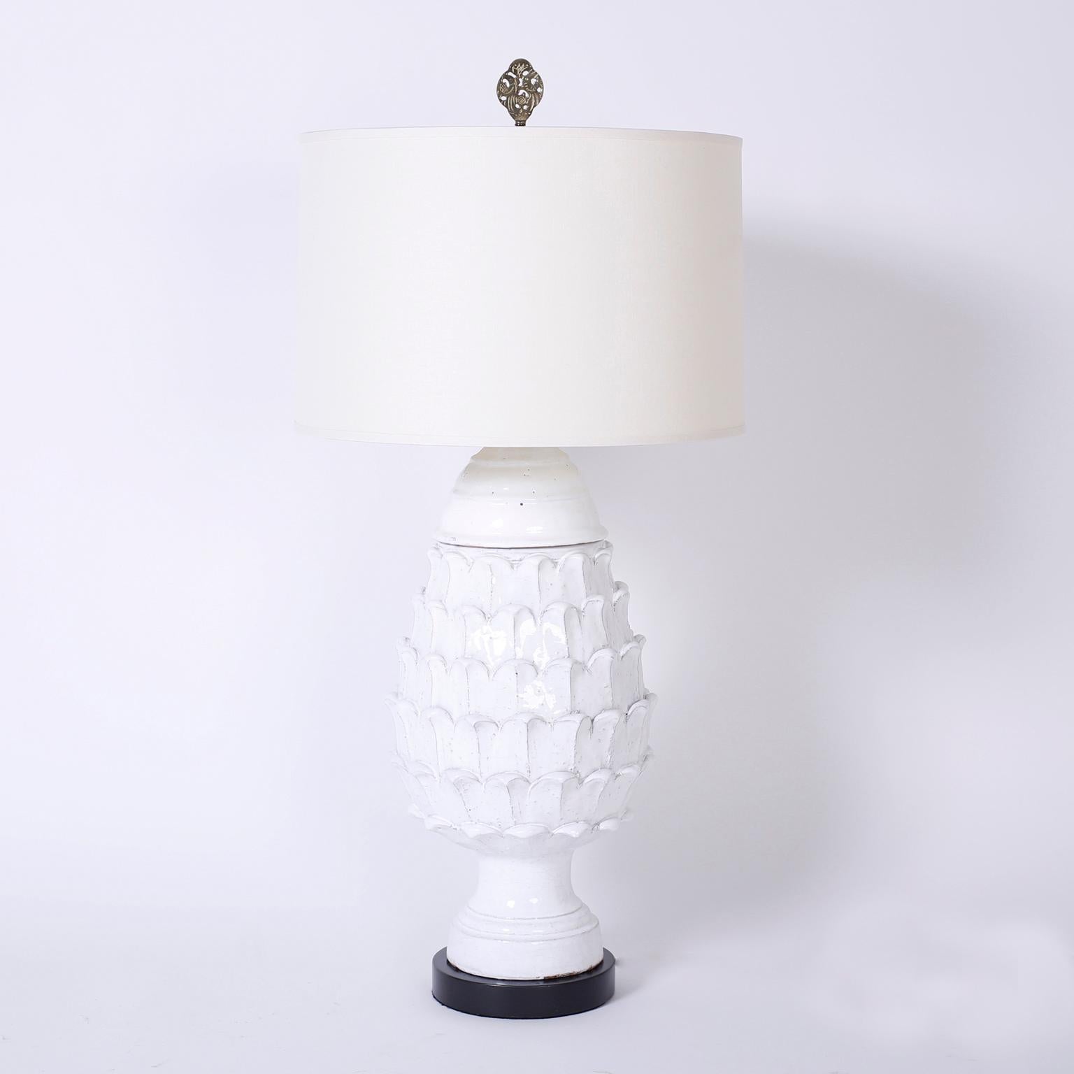 Swank pair of mid century artichoke terracotta table lamps with a translucent white glaze and a bold presence.