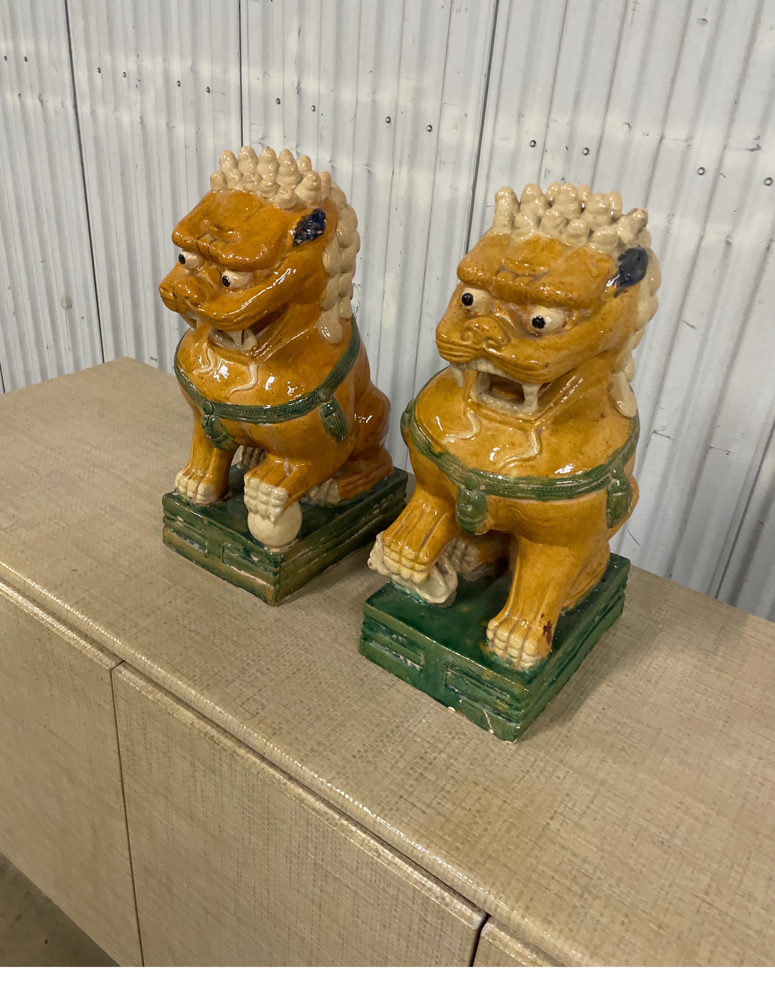 Pair of multicolored vintage glazed terra cotta Chinese foo dogs. These very imposing foo lions will look good in multiple settings inside or out.