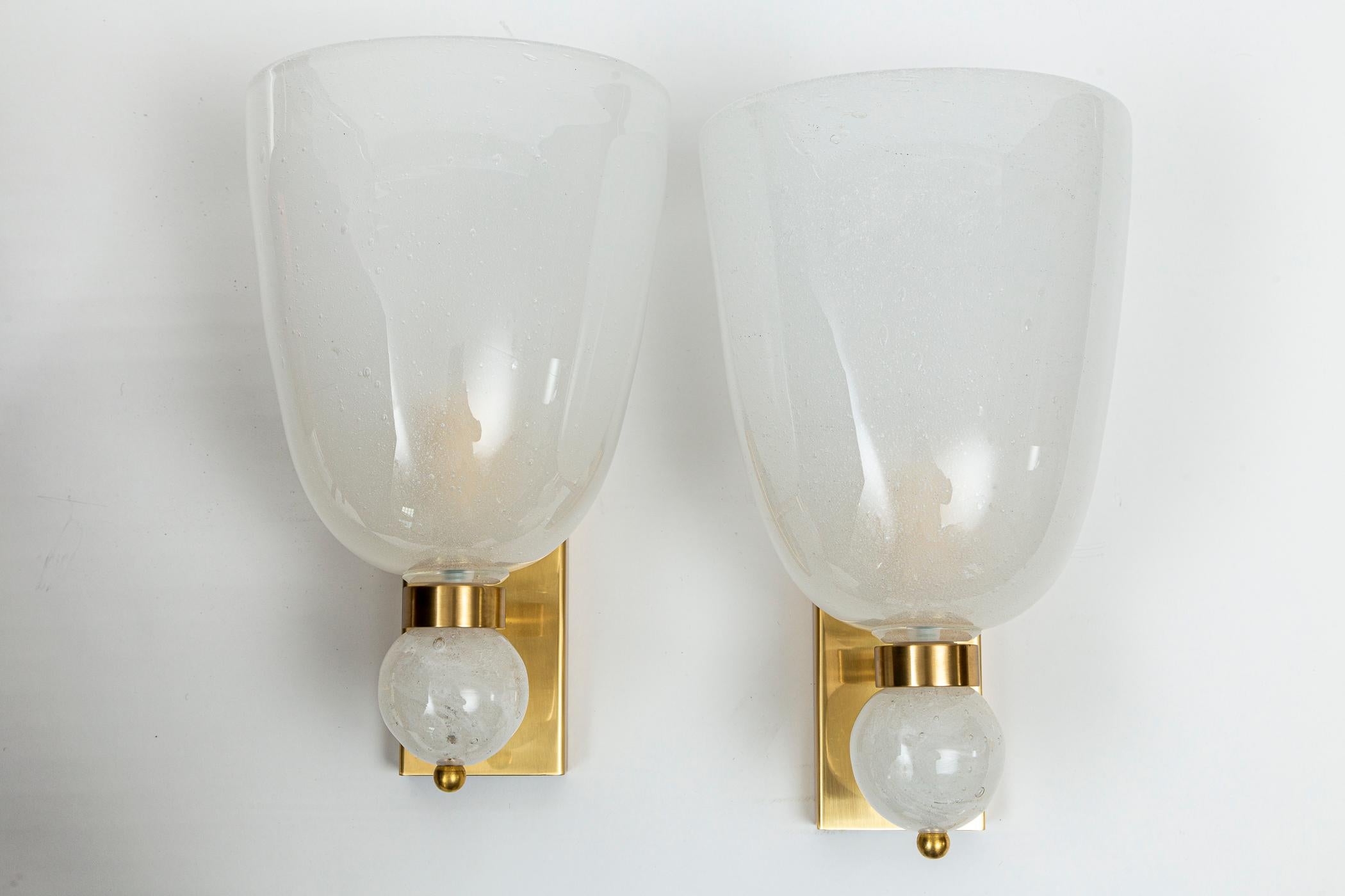 Large pair of Pulegoso blown Murano wall lights with large oval shaped shade and large ball finial, note uneven blown edges, hardware in unlacquered brass (which will oxidize shortly).  'Pulegoso' glass is a blowing technique containing numerous