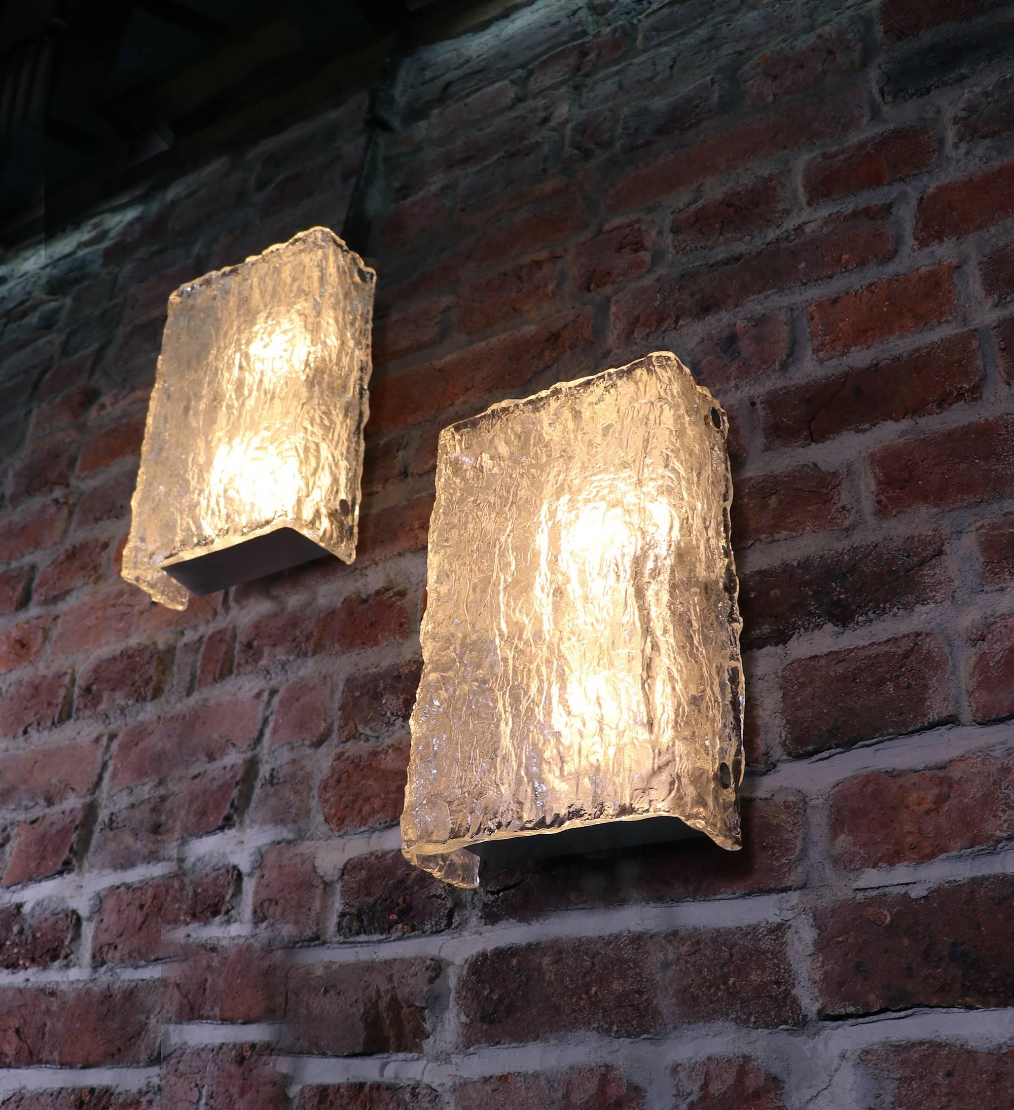Large pair of Murano ice glass wall lights by Kaiser Leuchten from 1960s,
each with one thick ice looking bend glass shade with four chrome fittings holds.
Each lamp takes two large Edison bulbs E27.
Measurements: 12.8 x 8 x 4.3 in. / 32.5 x 20.5
