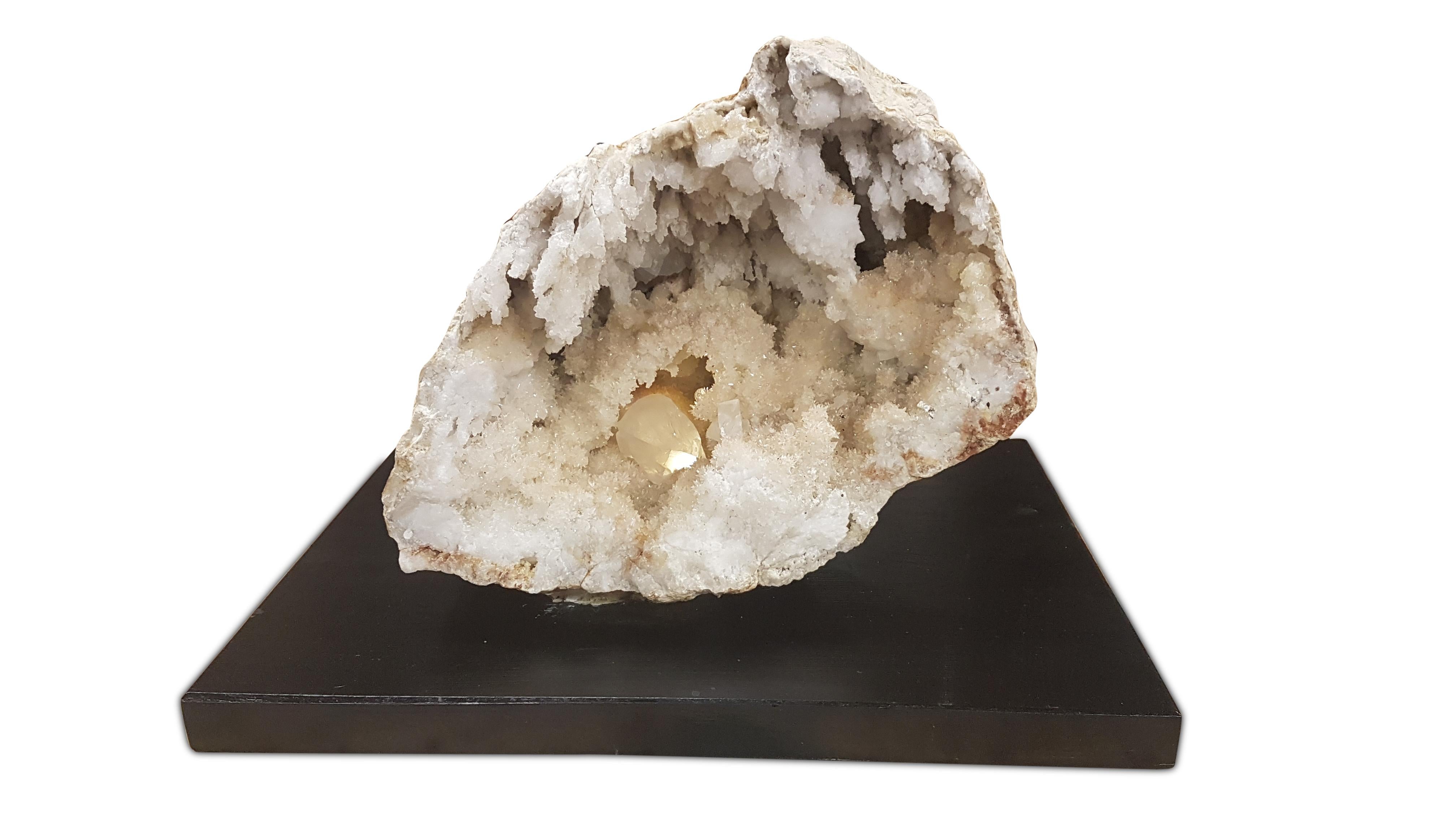 A very unusual pair of natural geodes formed in sandstone, the crystal Formations inside are quartz. These halves are two halves of one formation that has split in two. They have been attached to custom made black painted beech bases with Industrial