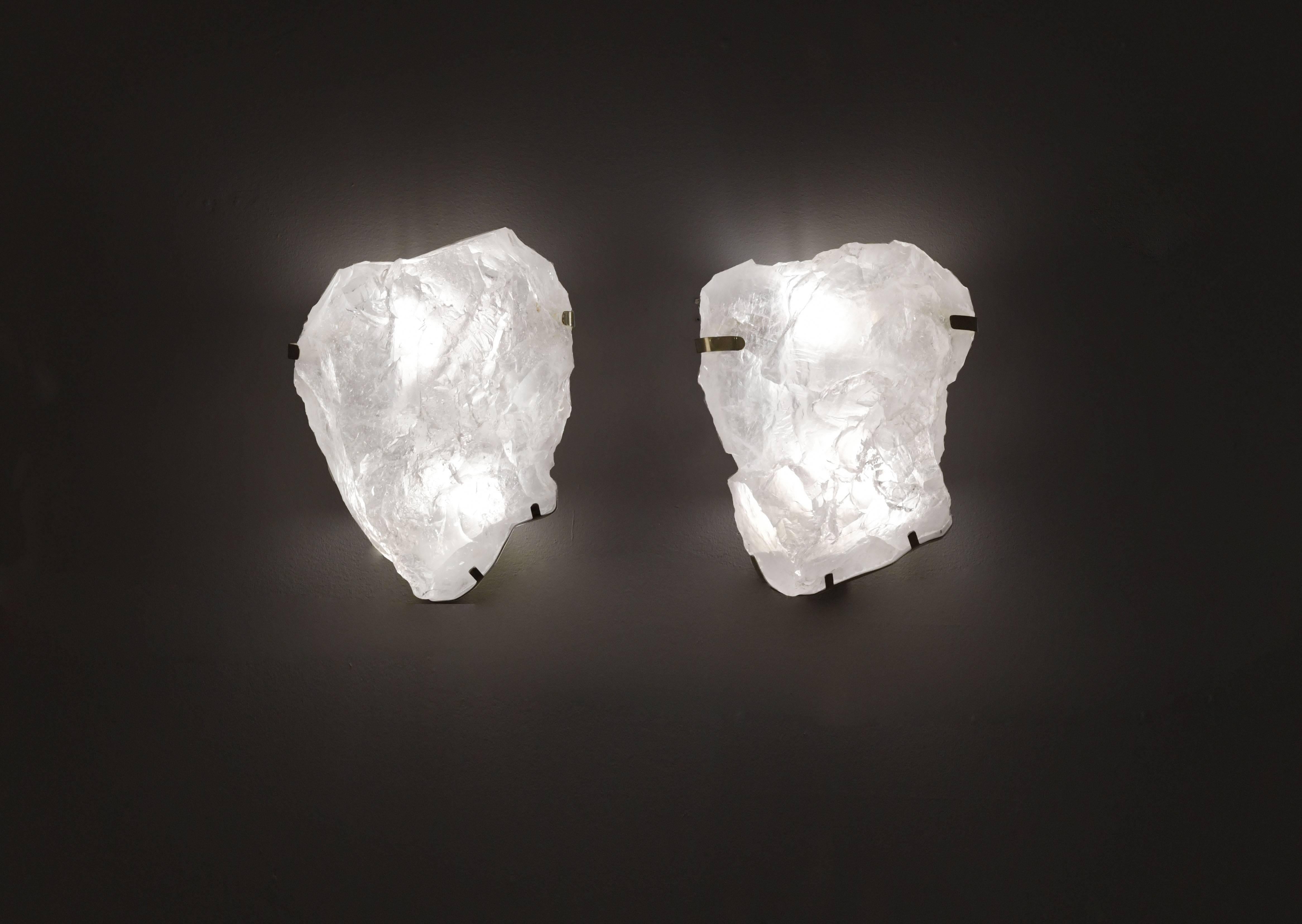 pair of natural rock crystal quartz wall sconces with antique brass-mounted, selected from natural rock crystal with beautiful natural surface. The shape of the sconces is the only pair in the world.created by Phoenix gallery. Custom measurement and