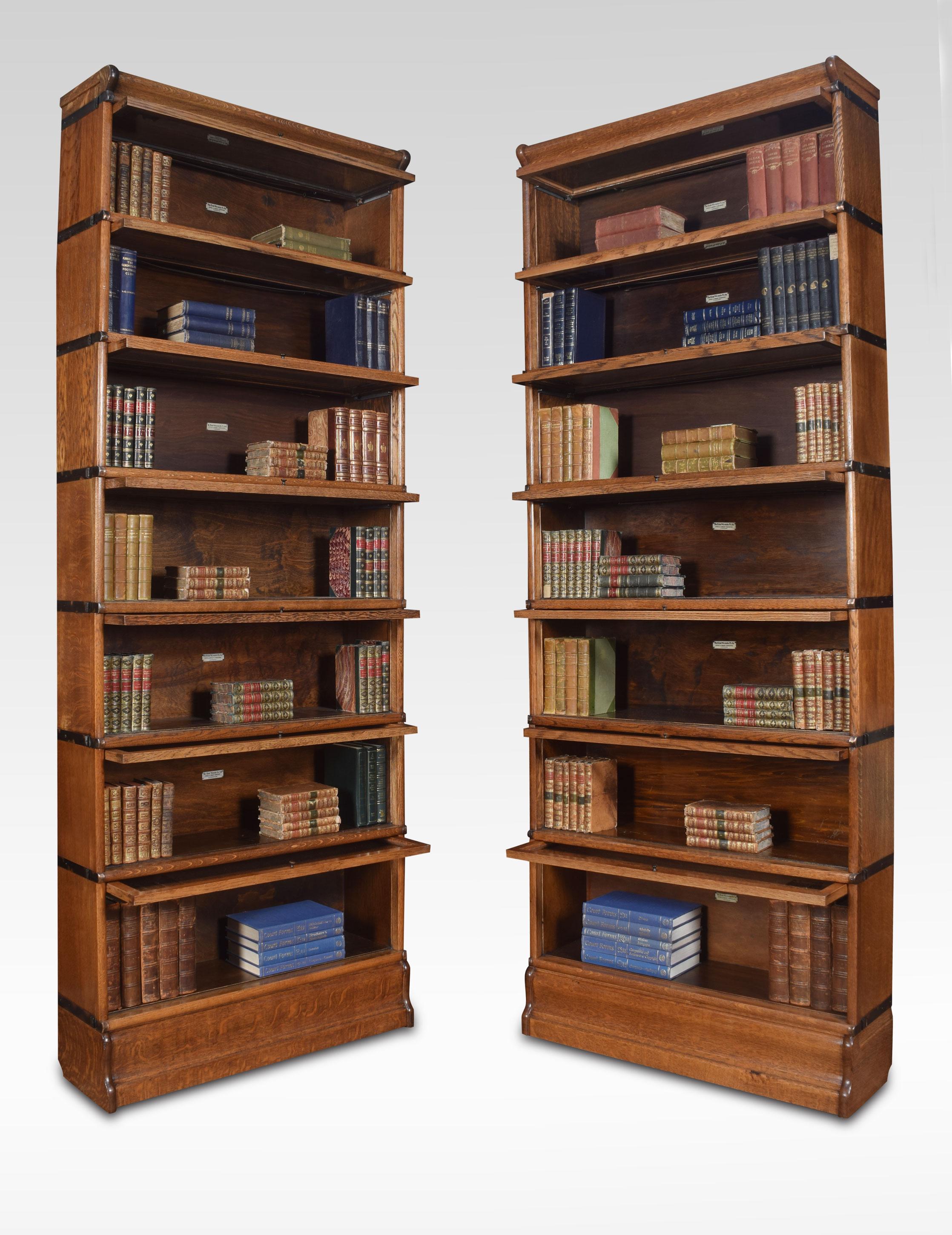 Pair of oak seven-section bookcases, the moulded top above seven section having glazed doors. All raised up on plinth base
Dimensions
Height 90.5 inches
Width 34 inches
Depth 11 inches.