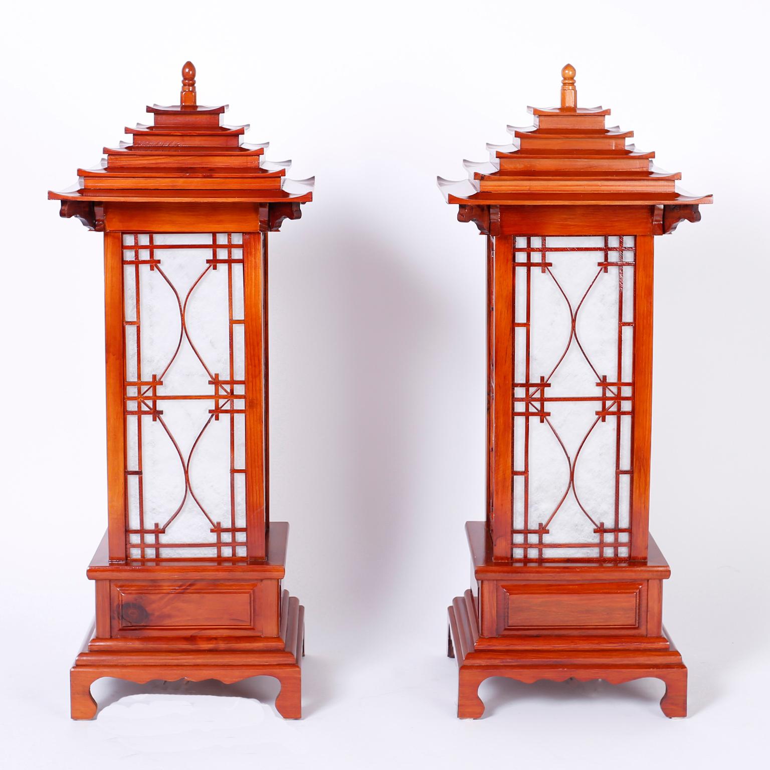Striking pair of table lamps with a classic pagoda form and strong architectural presence, crafted in pine and each having four panels of pearlized plastic light defusers that glow in mood or brighter light.