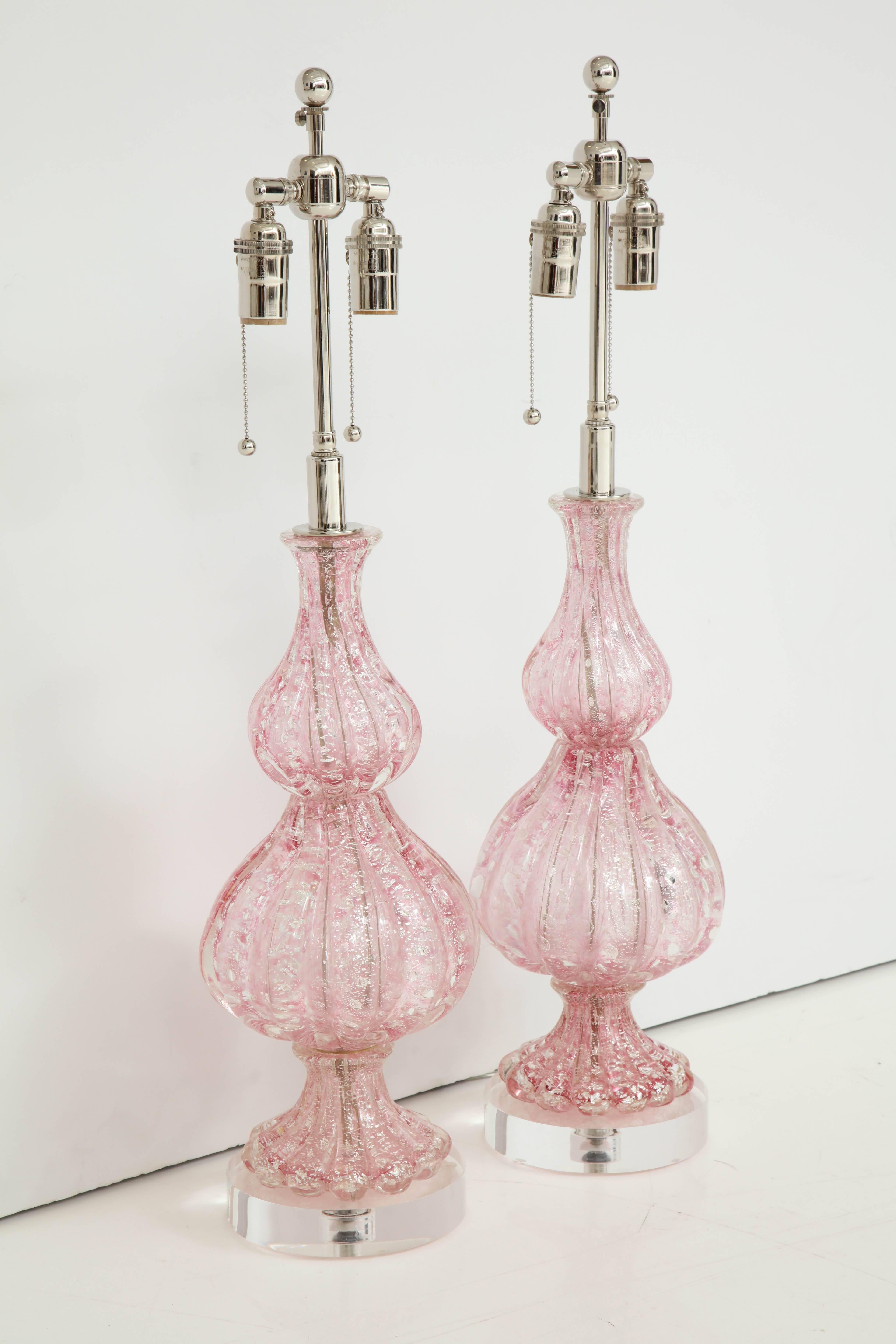 1950s Pair of large Pink Murano lamps by Barovier.
The glass lamp bodies have silver flecks controlled throughout and they are mounted on thick Lucite bases.
The lamps have been newly rewired for the US with polished Nickel double clusters that