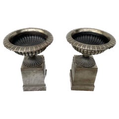 Large Pair Of Polished Steel English Urns On Stands