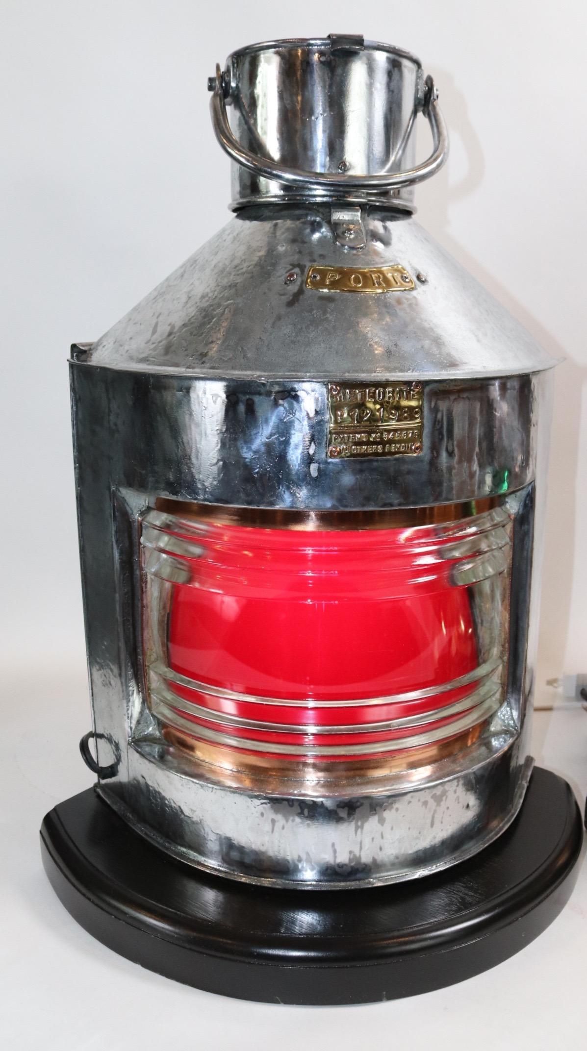Large pair of meteorite ships port and starboard lanterns in polished steel cases with clear Fresnel glass lenses and colored red and green filters. Mounted to thick wood bases with routed edges and rich dark finish. Both have been electrified for