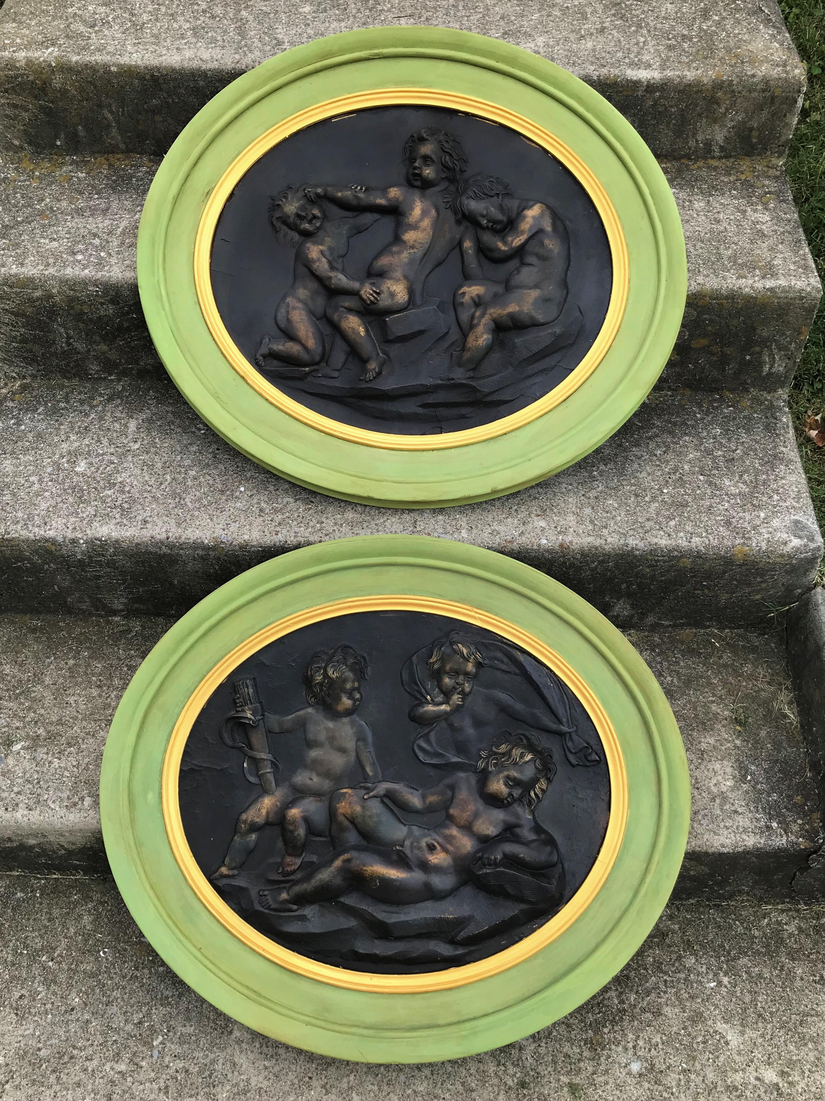 Set of continental composition wall plaques or medallions of frolicking or playful putti / cherubs (children). Mint green wood frame.

Chips, nicks, wear to frames, probably a later paint or repaint. The patinated center subjects in very good