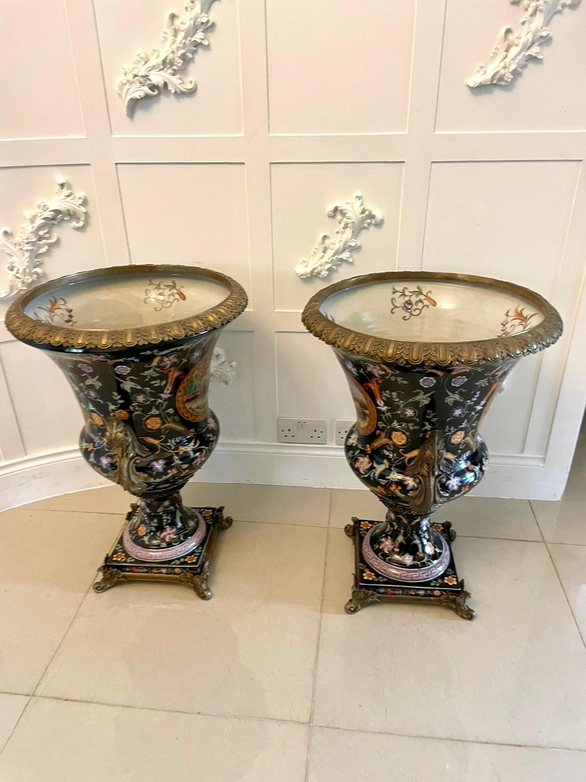 Large pair of quality antique 19th century porcelain and ornate brass mounted vases
having an ornate beautiful brass circular top with hand painted decoration to the inside of the vase above a large porcelain vase with wonderful hand painted panels