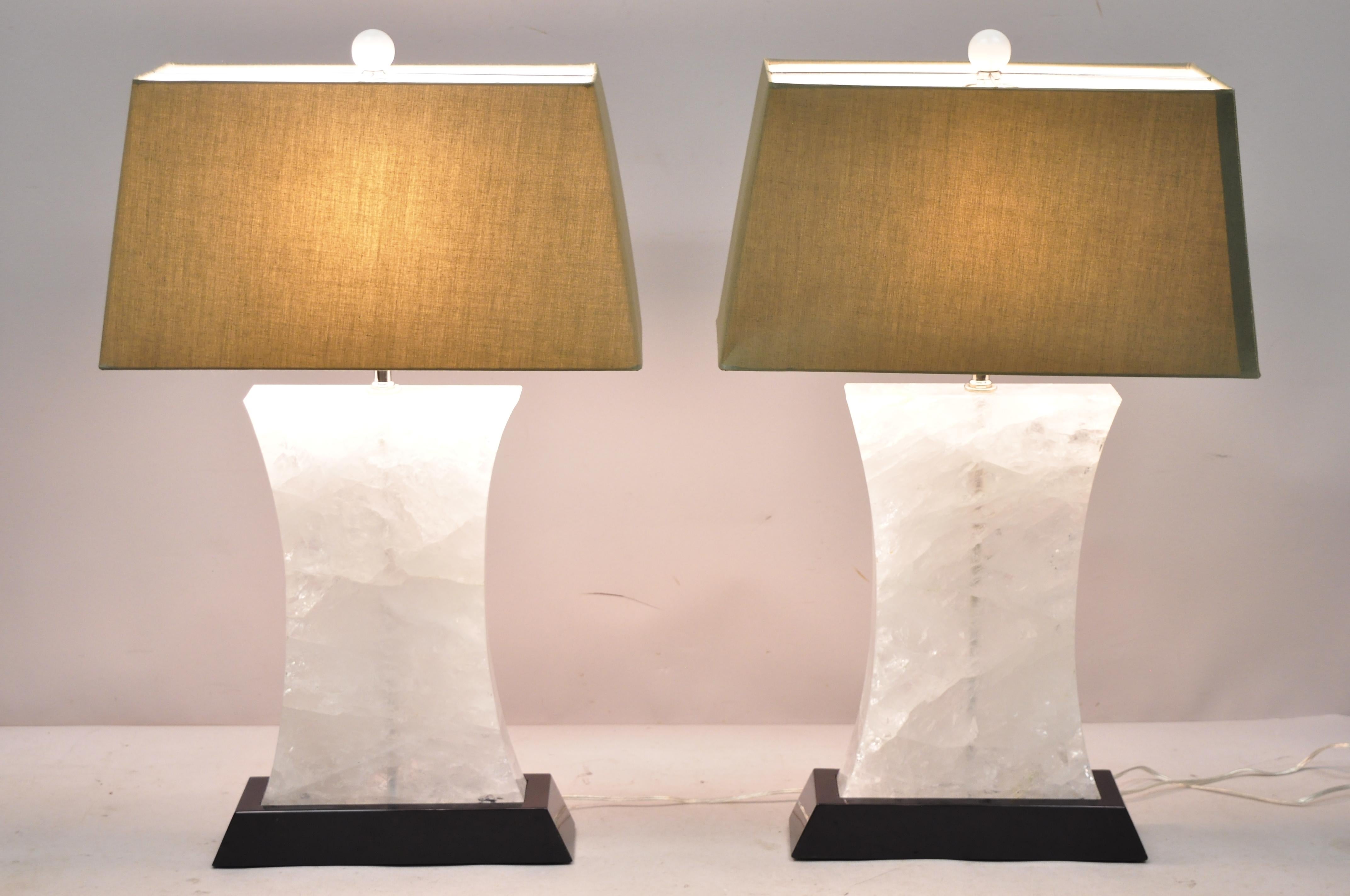 Large pair of rock crystal quartz hourglass modern table lamps. Listing includes heavy and stunning rock crystal forms, black lacquer wooden bases, original shades, clean modernist lines, great style and form, circa early 21st century. Measurements: