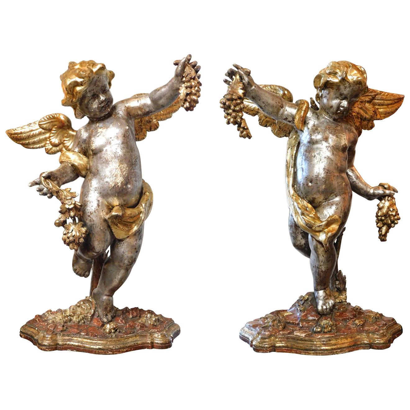 Large Pair of Roman Rococo Carved Giltwood Putti Harvesting Grapes For Sale