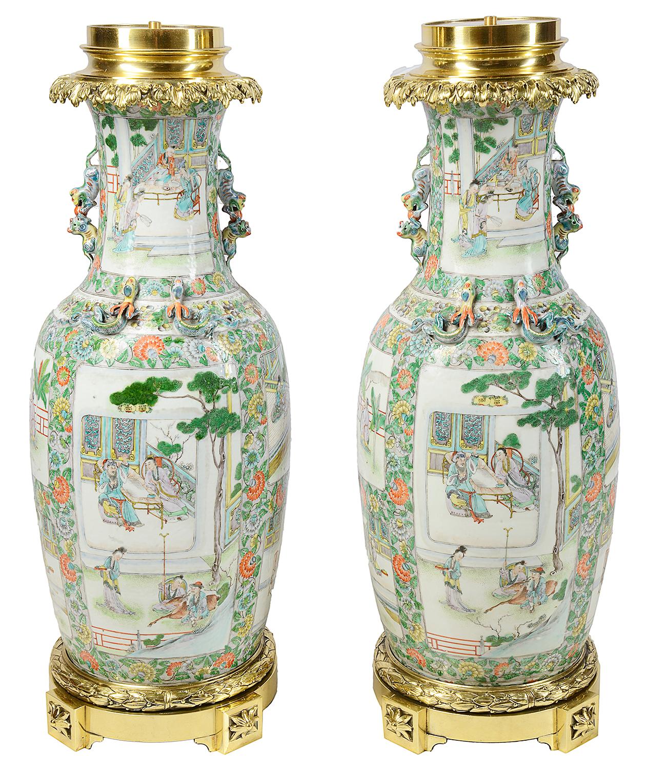 A good quality pair of 19th century Chinese rose medallion / Cantonese vases / lamps. Each having classical Chinese scenes of people in gardens and on verandas, floral background and mythical dog of faux handles. Mounted with ormolu tops and bases.