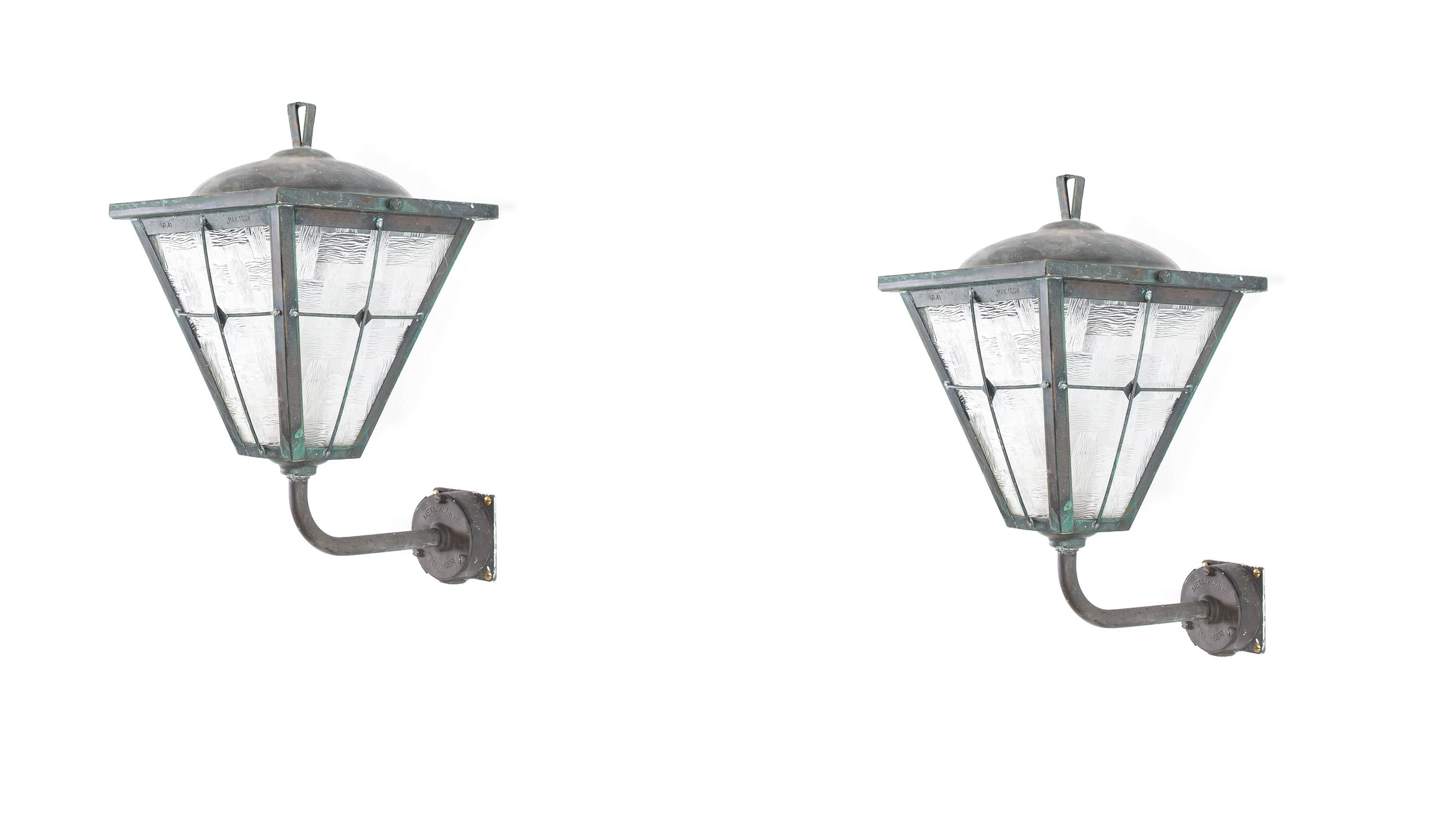 Pair of modernist outdoor wall lamps in patinated copper and glass. Designed and made in Norway from circa 1960s first half. Both lamps are fully working and in good vintage condition. The lamps are fitted with one E27 bulb holder (works in the US),