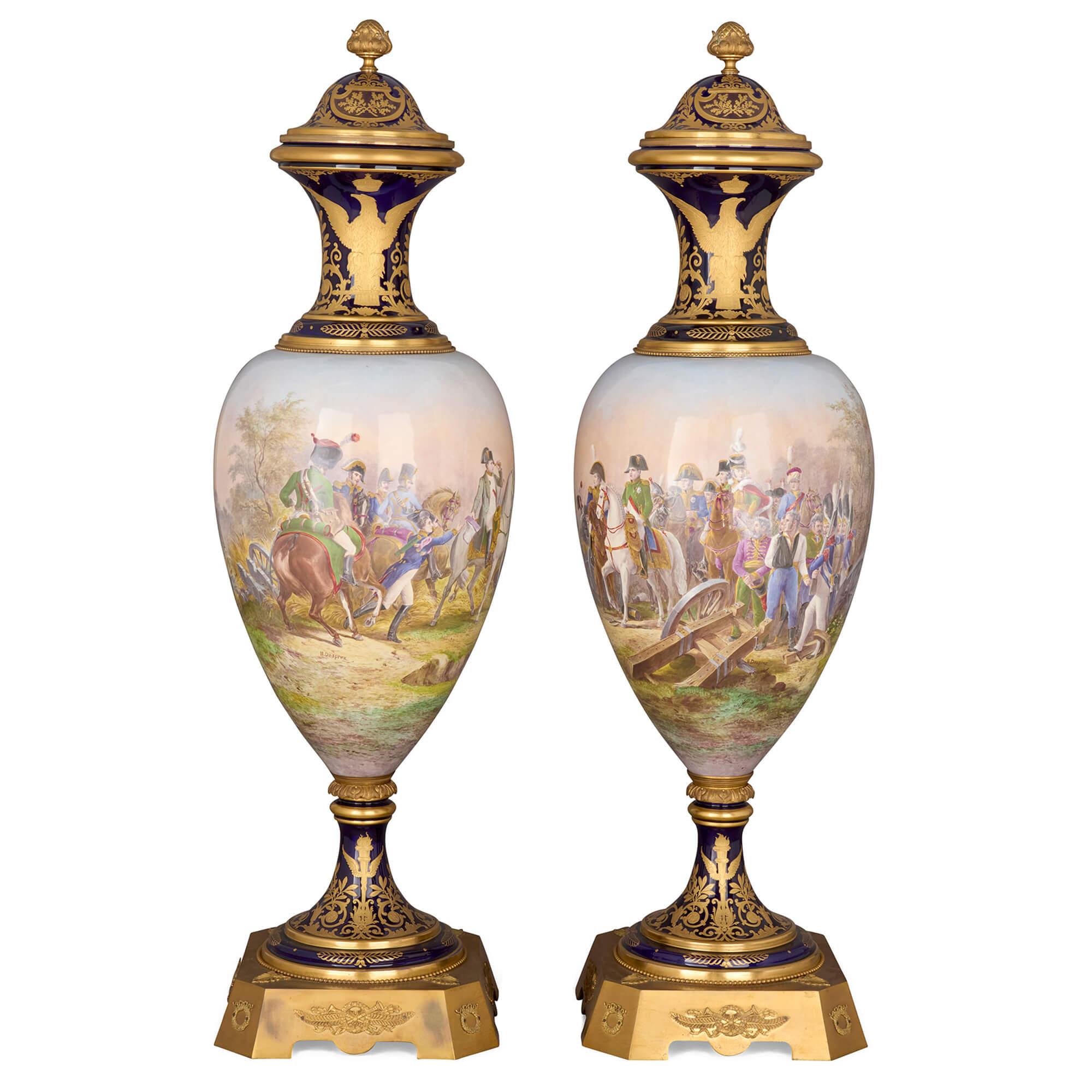 Large pair of Sèvres-style Napoleonic vases with ormolu mounts
French, Late 19th Century
Height 148cm, diameter 48cm

Of inverted ovoid form, these Sèvres-style vases combine elegant gilt detailing with painted scenes. The tapering bodies are