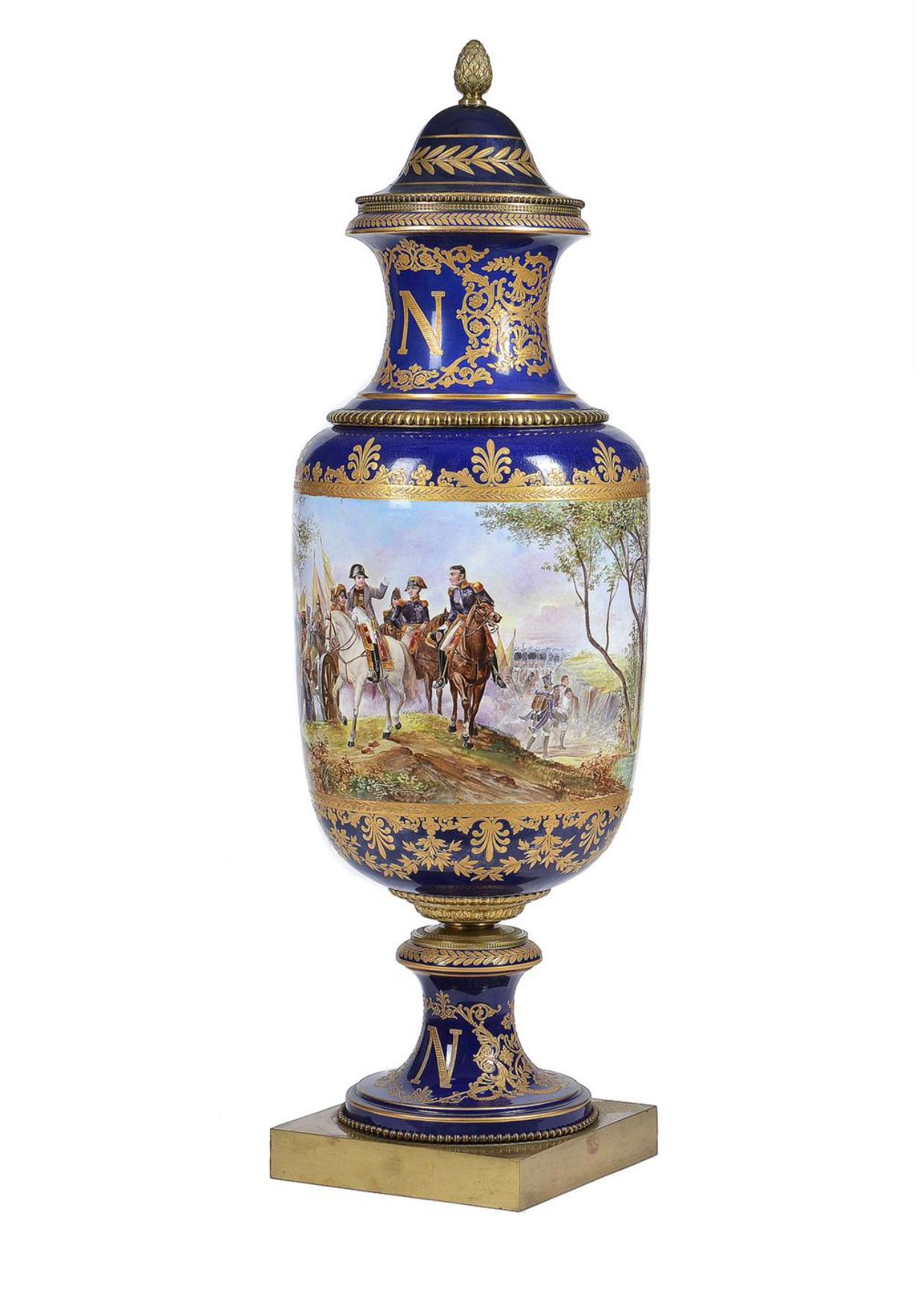A pair of Sevres style pottery gilt-metal mounted vases and covers decorated in the Imperial manner, circa 1900, painted with battle scenes after Horace Vernet of Bonaparte at the battles of Friedland and Wagram, signed H.F.M. Faraguet, reserved on