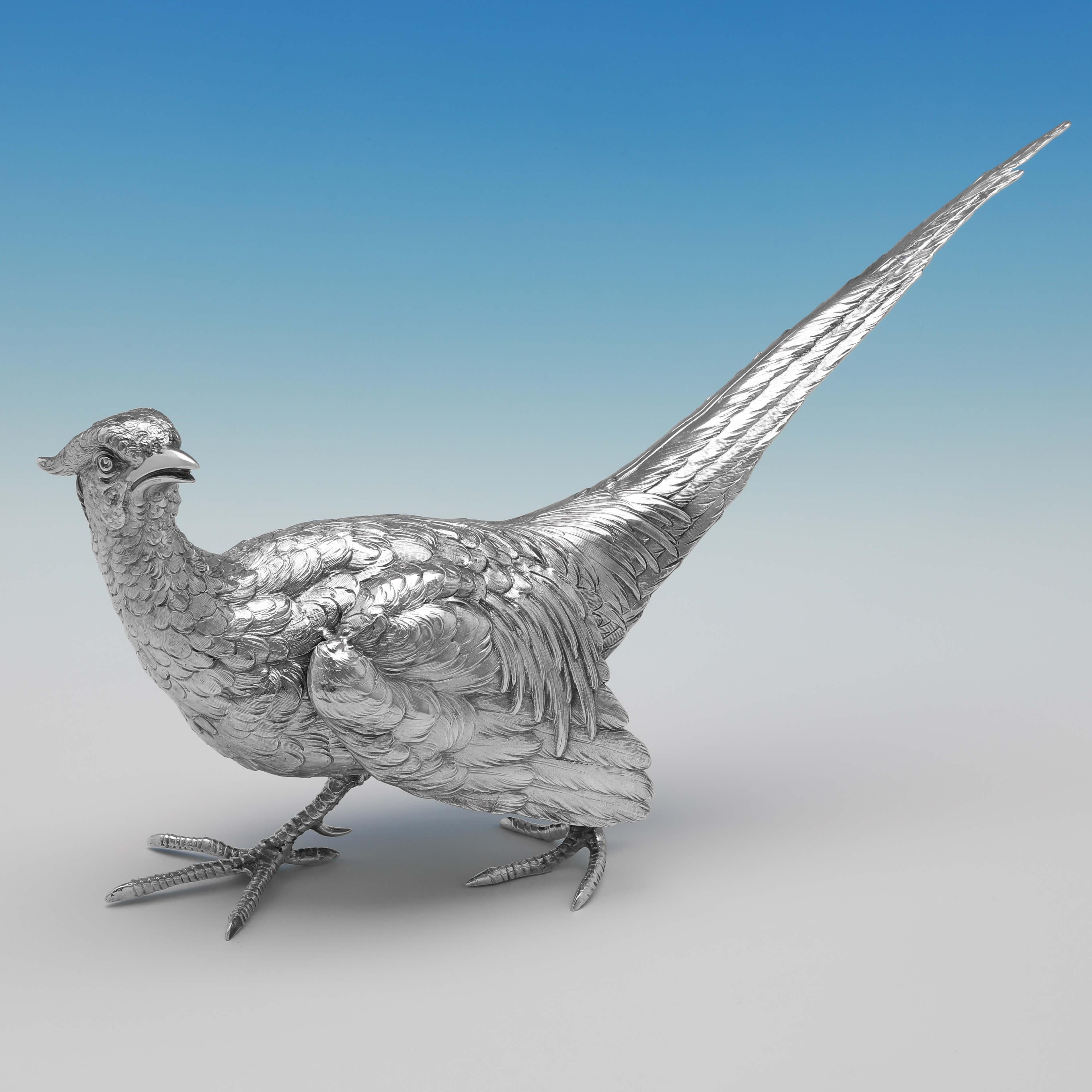 Carrying import marks for London in 1922 & Chester in 1909 by Berthold Muller, this striking pair of sterling silver pheasants, are realistically modelled and hand chased. The male (hallmarked in Chester) measures: 9.75