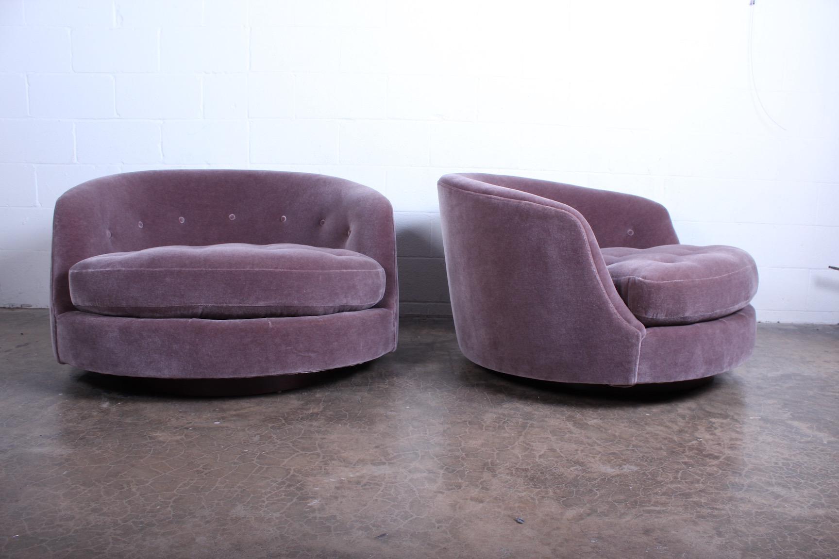 A pair of oversized swivel chairs on walnut bases newly upholstered in Mohair. Designed by Milo Baughman for Thayer Coggin.