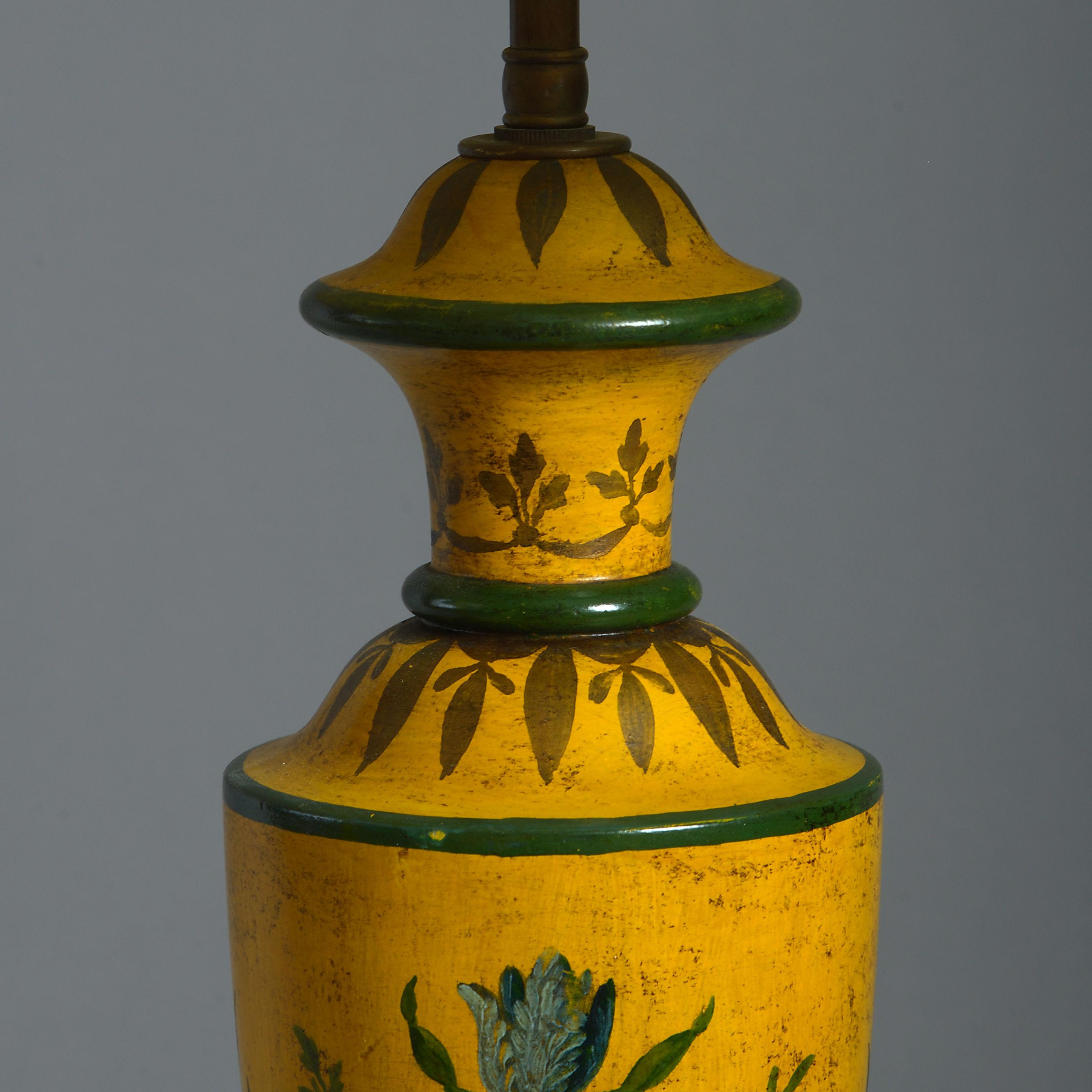 A large pair of tole lamp bases, taking the form of urns and decorated throughout with polychrome floral motifs upon a deep yellow ground. 

Dimensions listed refer to lamp bases.