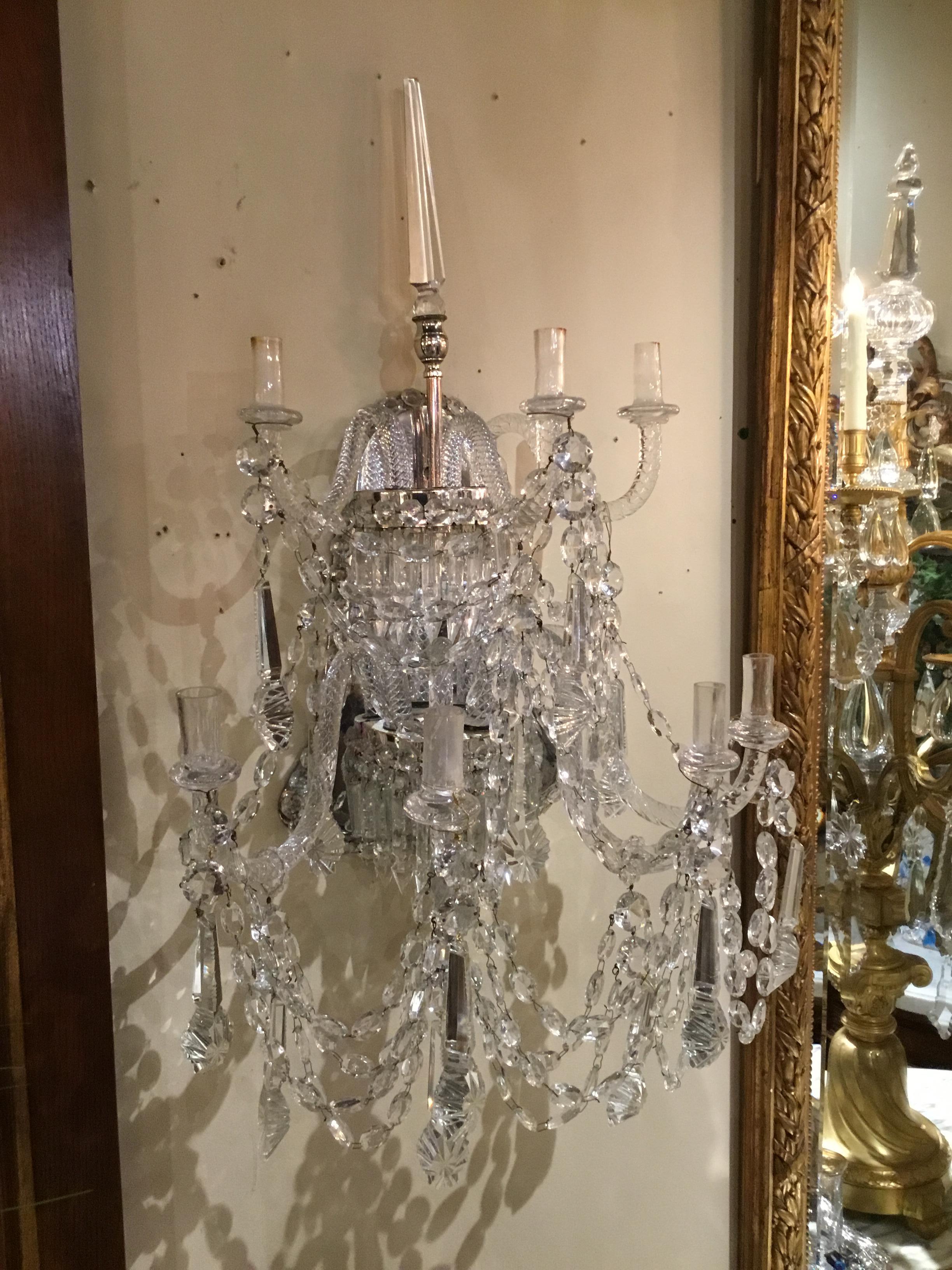 Exceptional quality Venetian sconces with silver metal back, seven arms, single spire at the
Center top. Notched crystal in the center arched position. Seven glass arms support 
The candelabrum. Lovely condition, without chips or missing pieces.