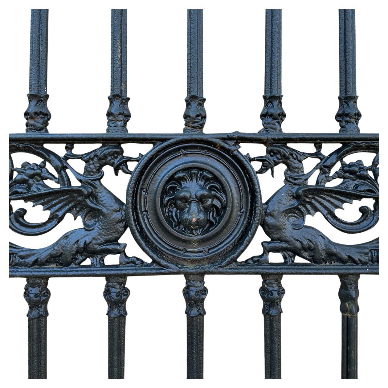 A large pair of drive way or entrance gates in cast iron by renowned Foundry originally founded in the English Regency Period. Incredibly decorative and very well cast with serpents, lions masks in roundels, scrolled foliate and cameo masks. Foundry